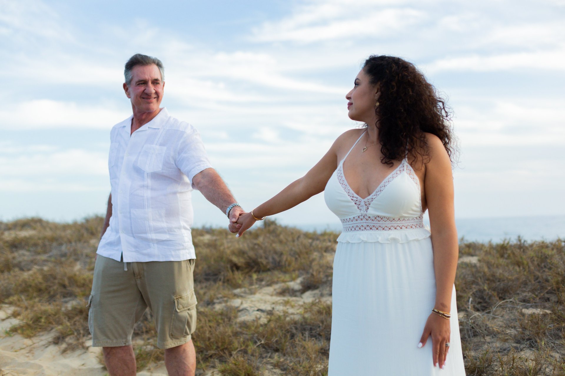 A moment captured by Los Cabos Wedding Films at the Garza Blanca Hotel in San José del Cabo: Bridesmaids raising their floral