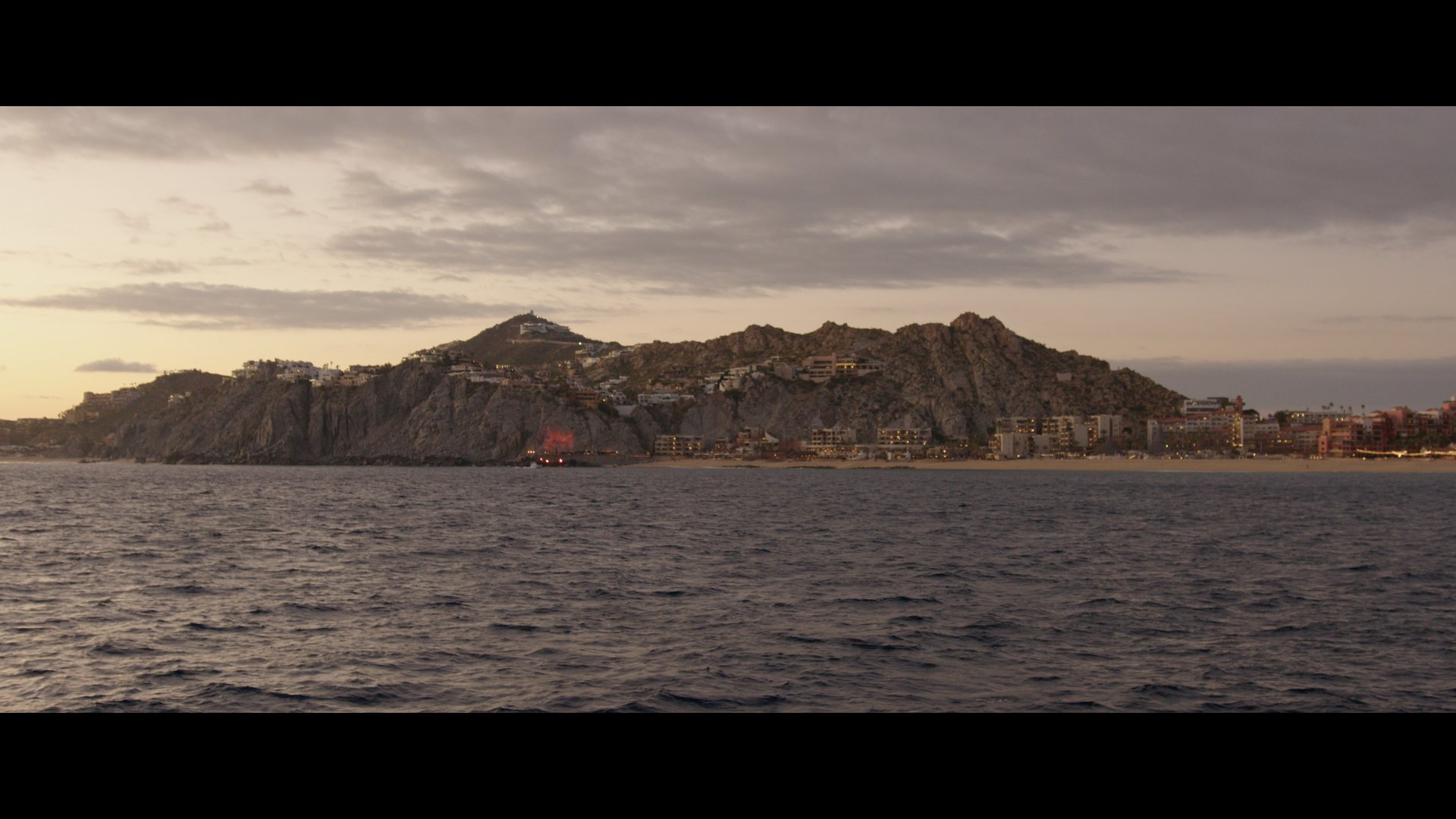 Image captured from a boat, showcasing a moment from a wedding video on a Cabo San Lucas beach