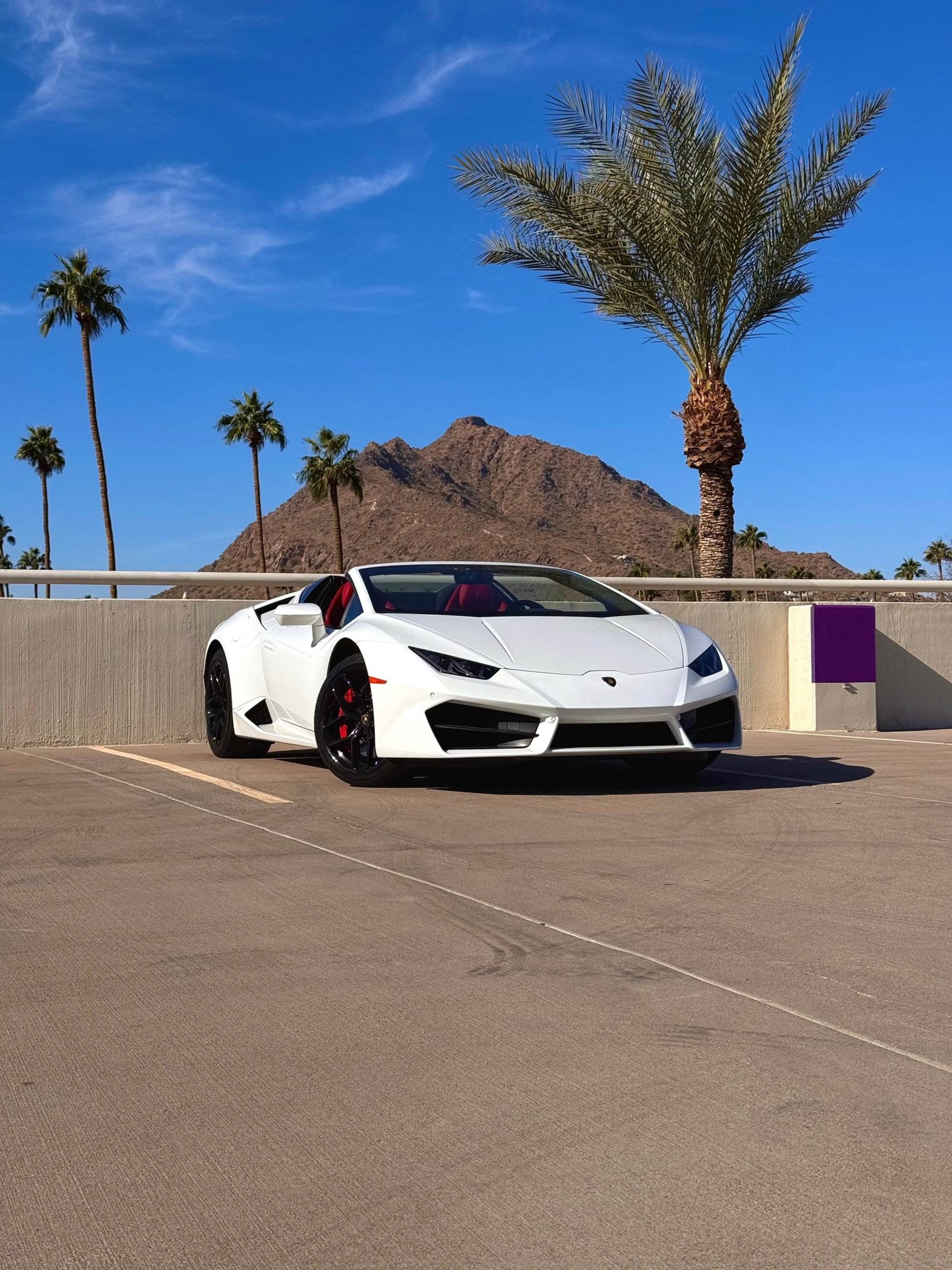 a row of cars parked on the side of a road