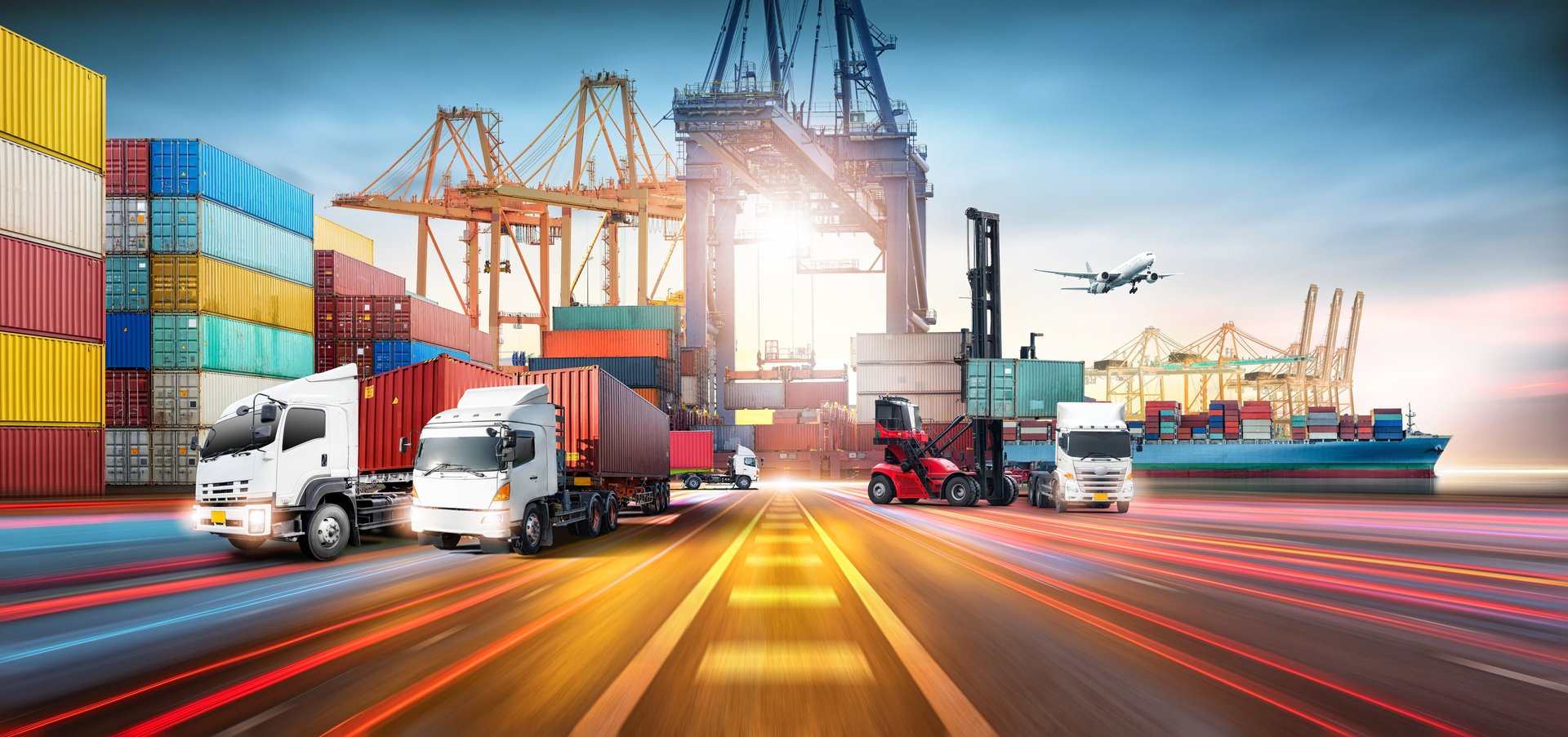 a truck is parked in front of a bunch of shipping containers