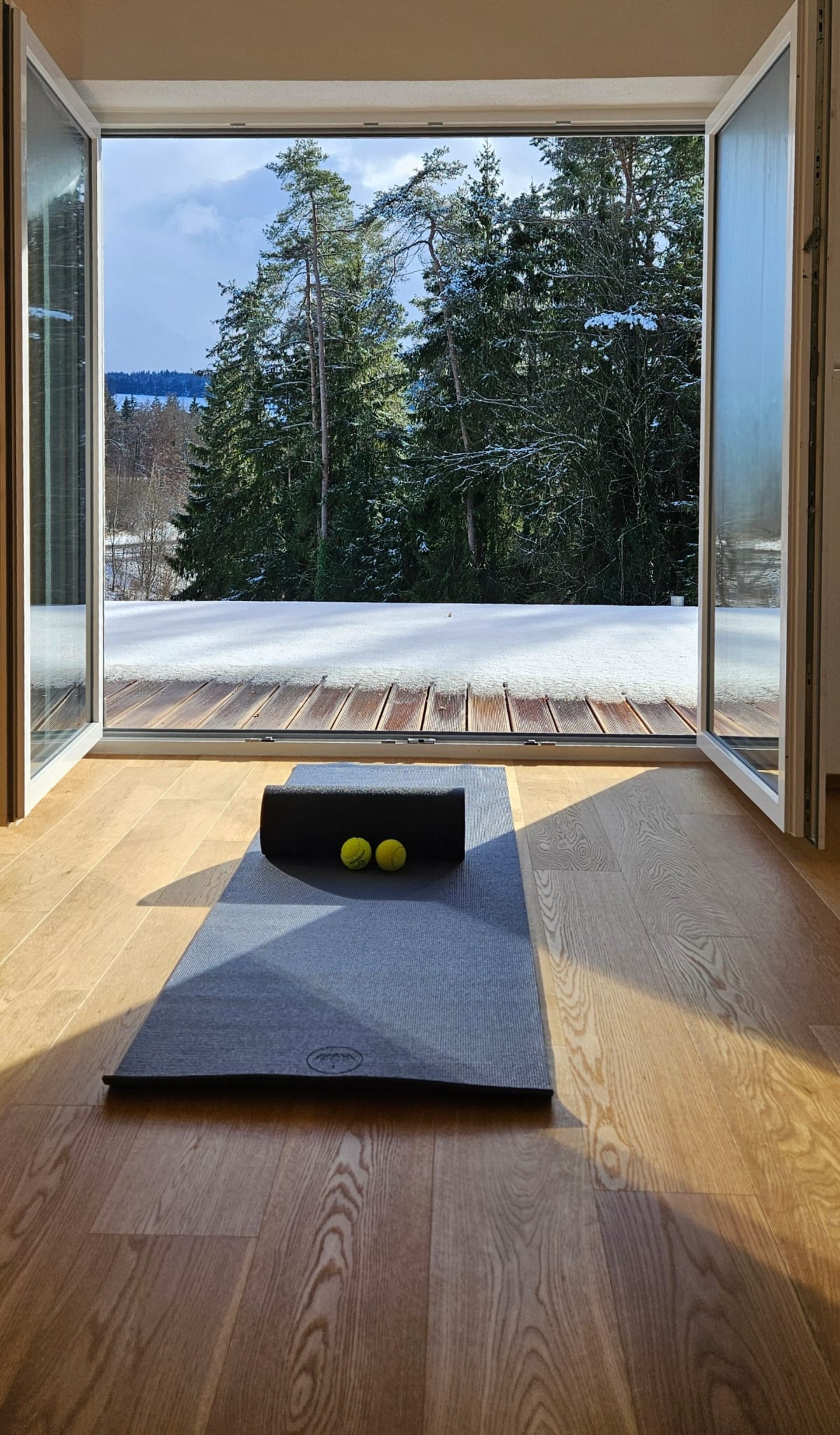 a woman laying on top of a black mat