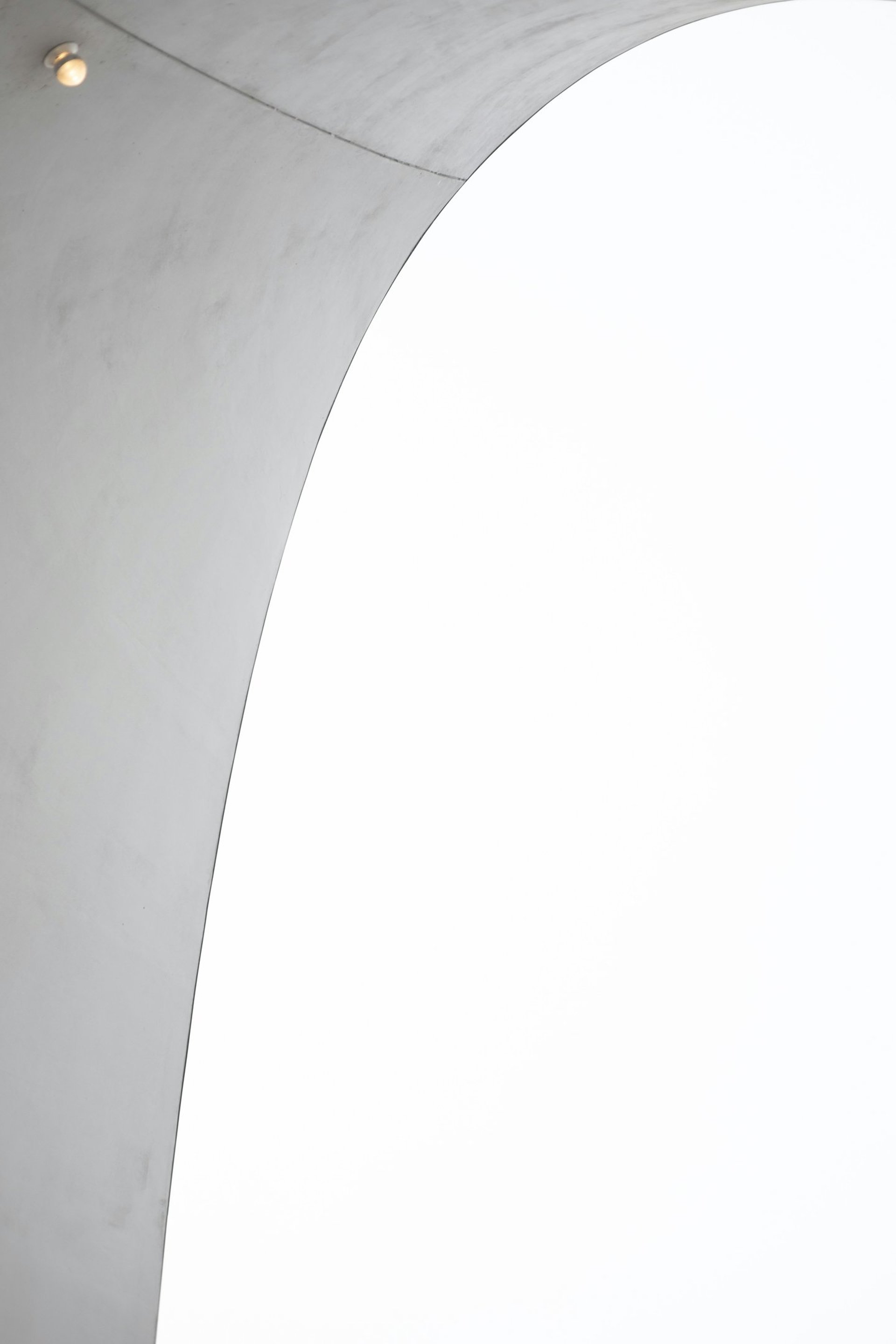 A man riding a skateboard up the side of a cement wall