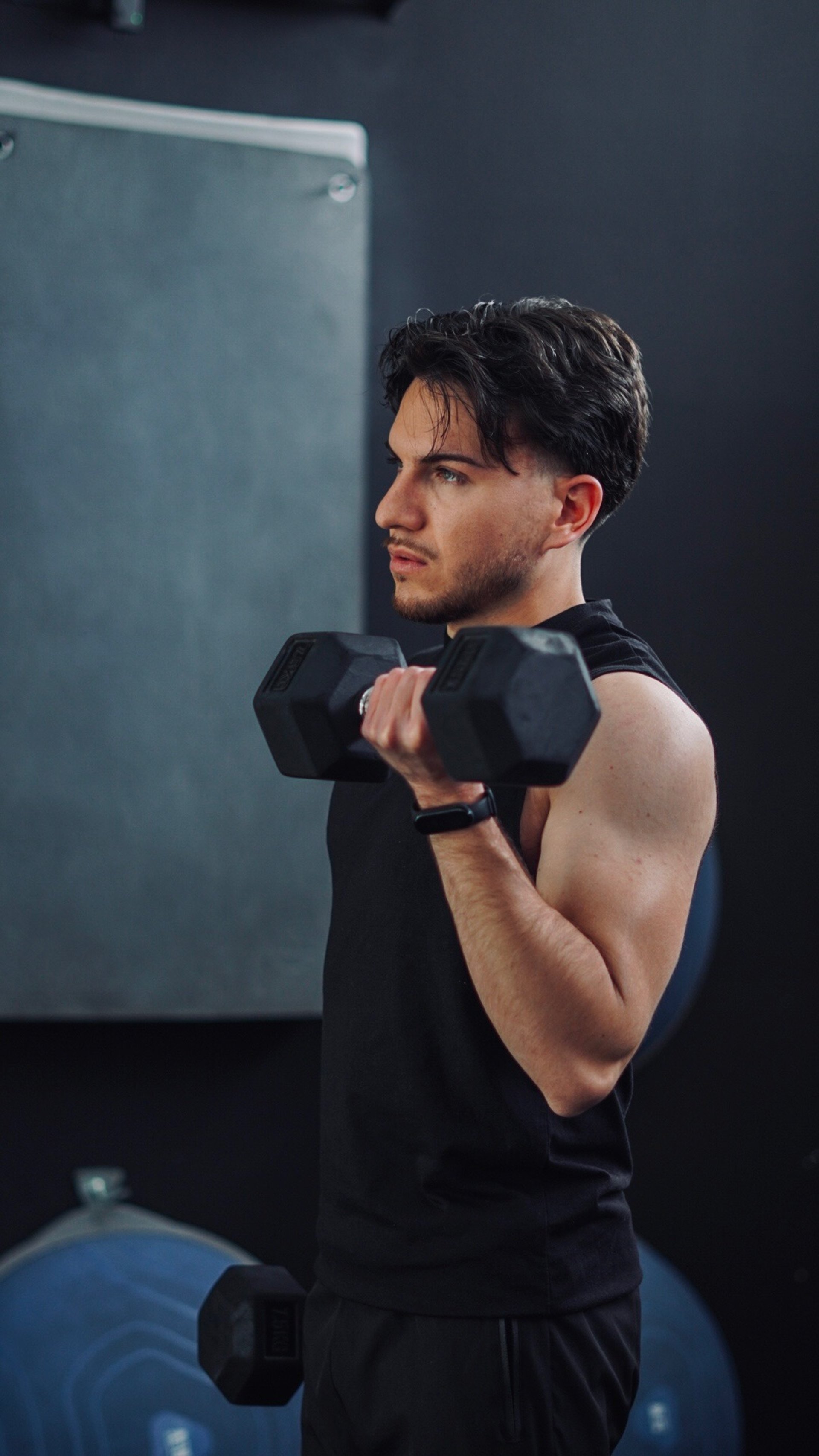 a man lifting a barbell in a gym