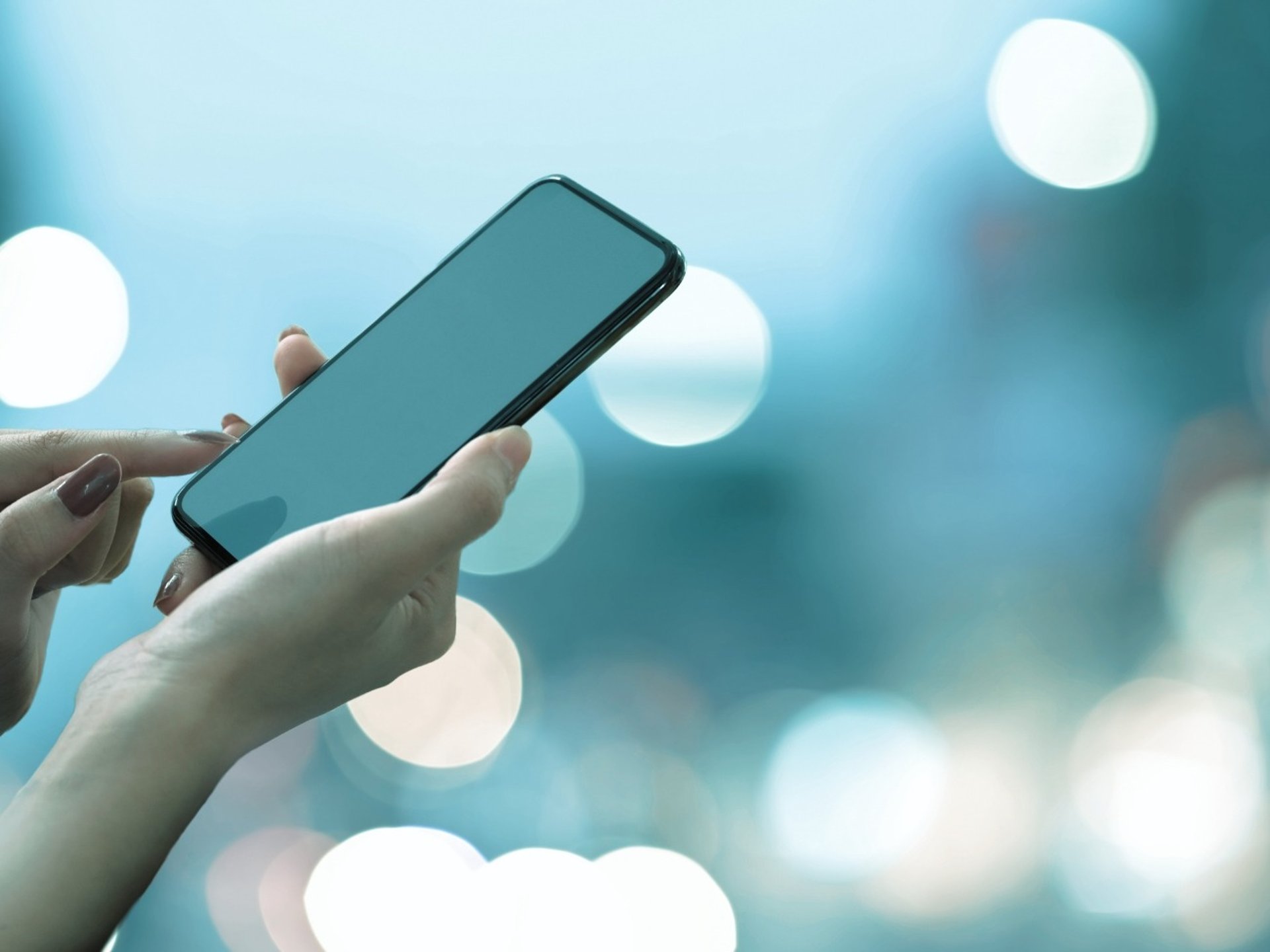 a woman holding a cell phone in her hands
