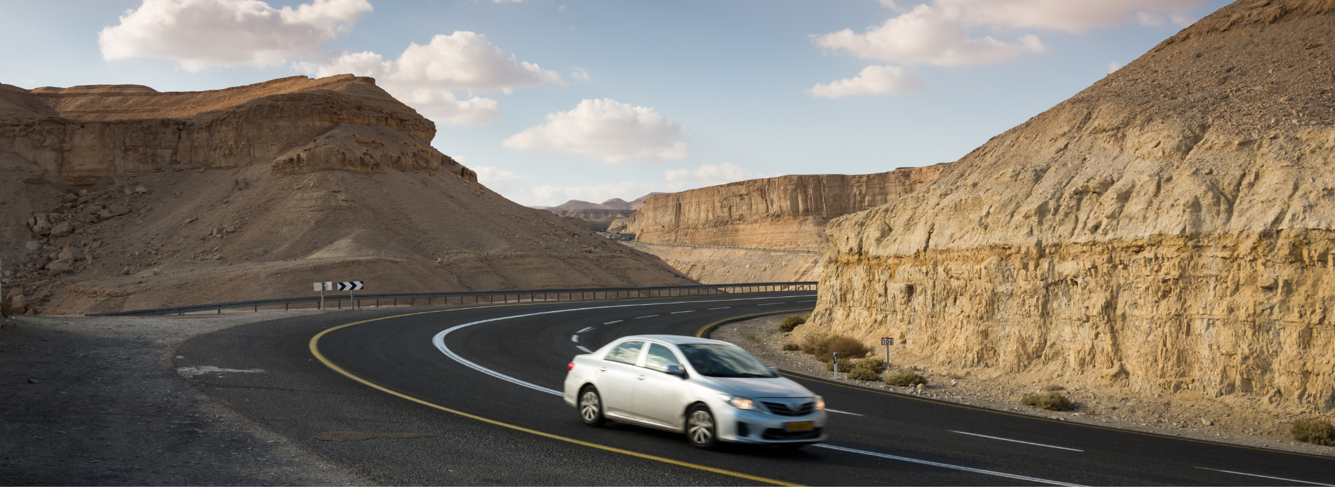 an abstract photo of a curved building with a blue sky in the background