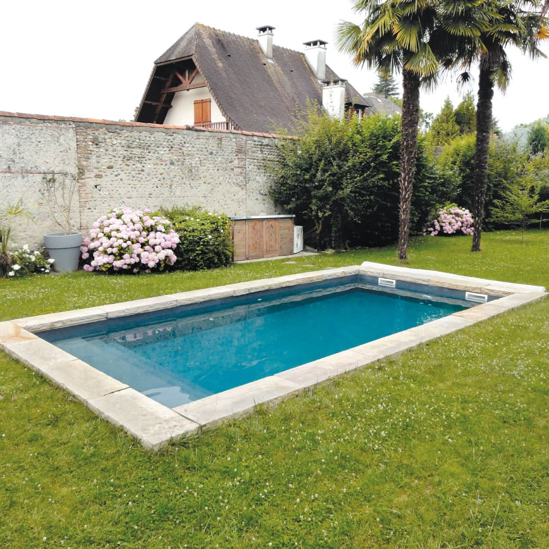 an abstract photo of a curved building with a blue sky in the background