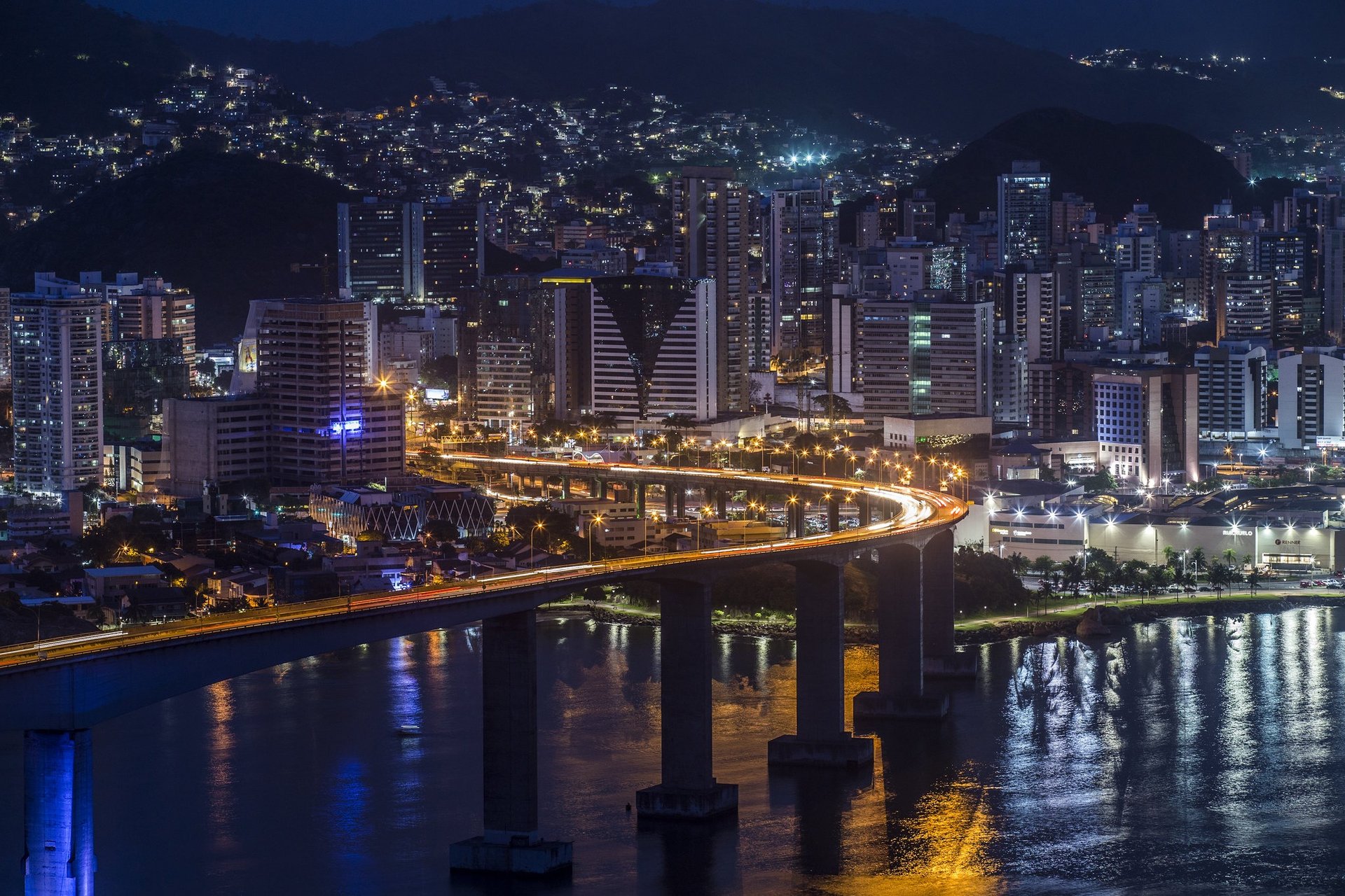 a large boat traveling down a river next to a bridge