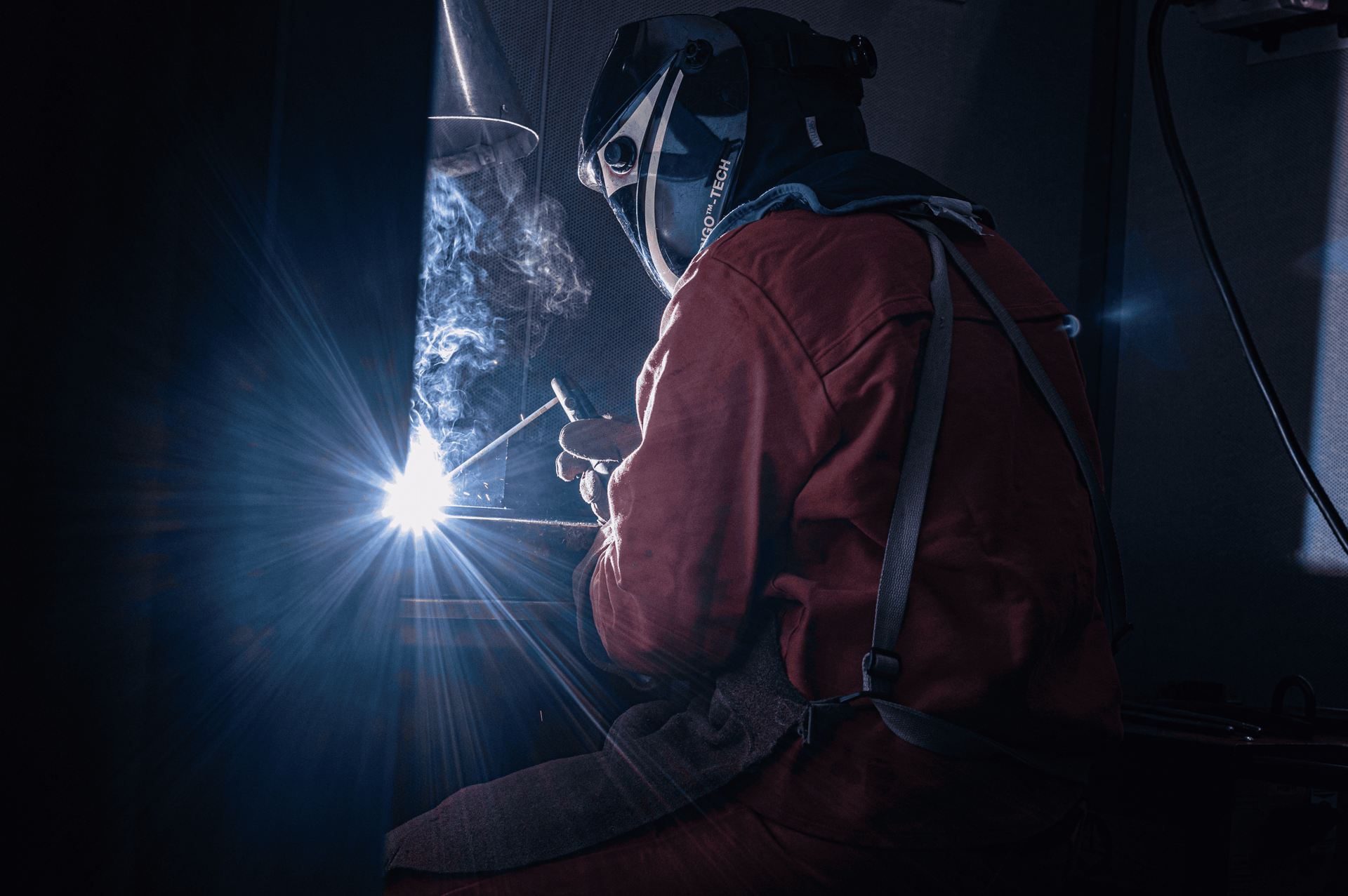 person in yellow hard hat and brown jacket