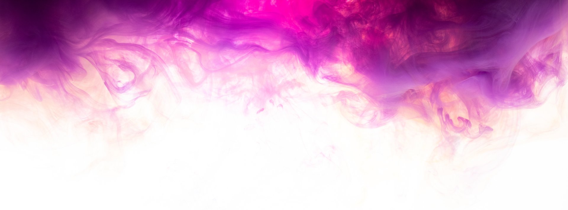 a red, yellow and blue smoke is in the air