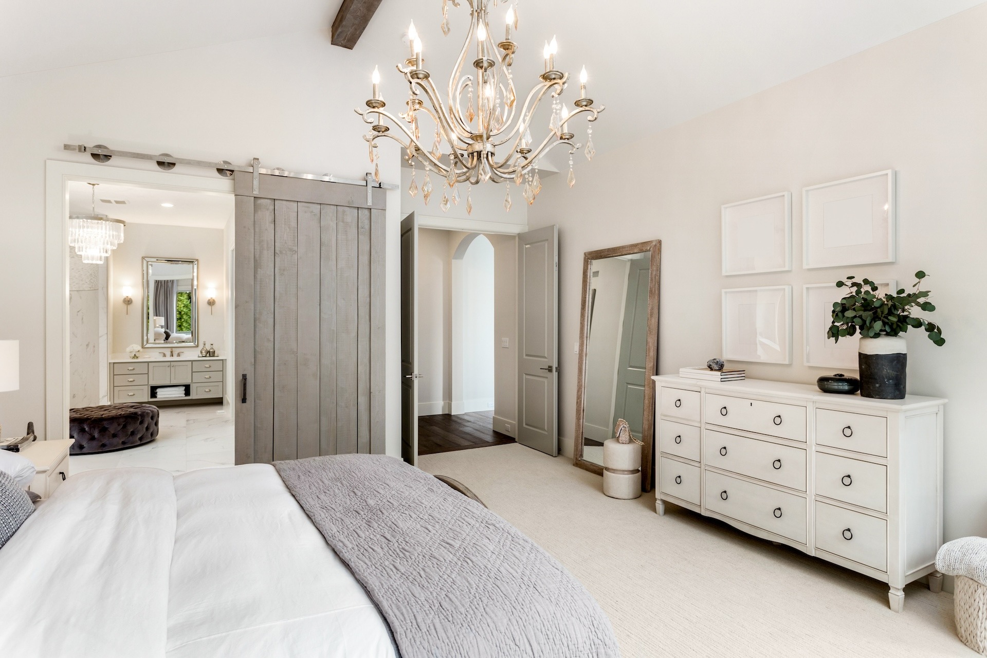 Elegant master bedroom featuring a crystal chandelier in Brighton