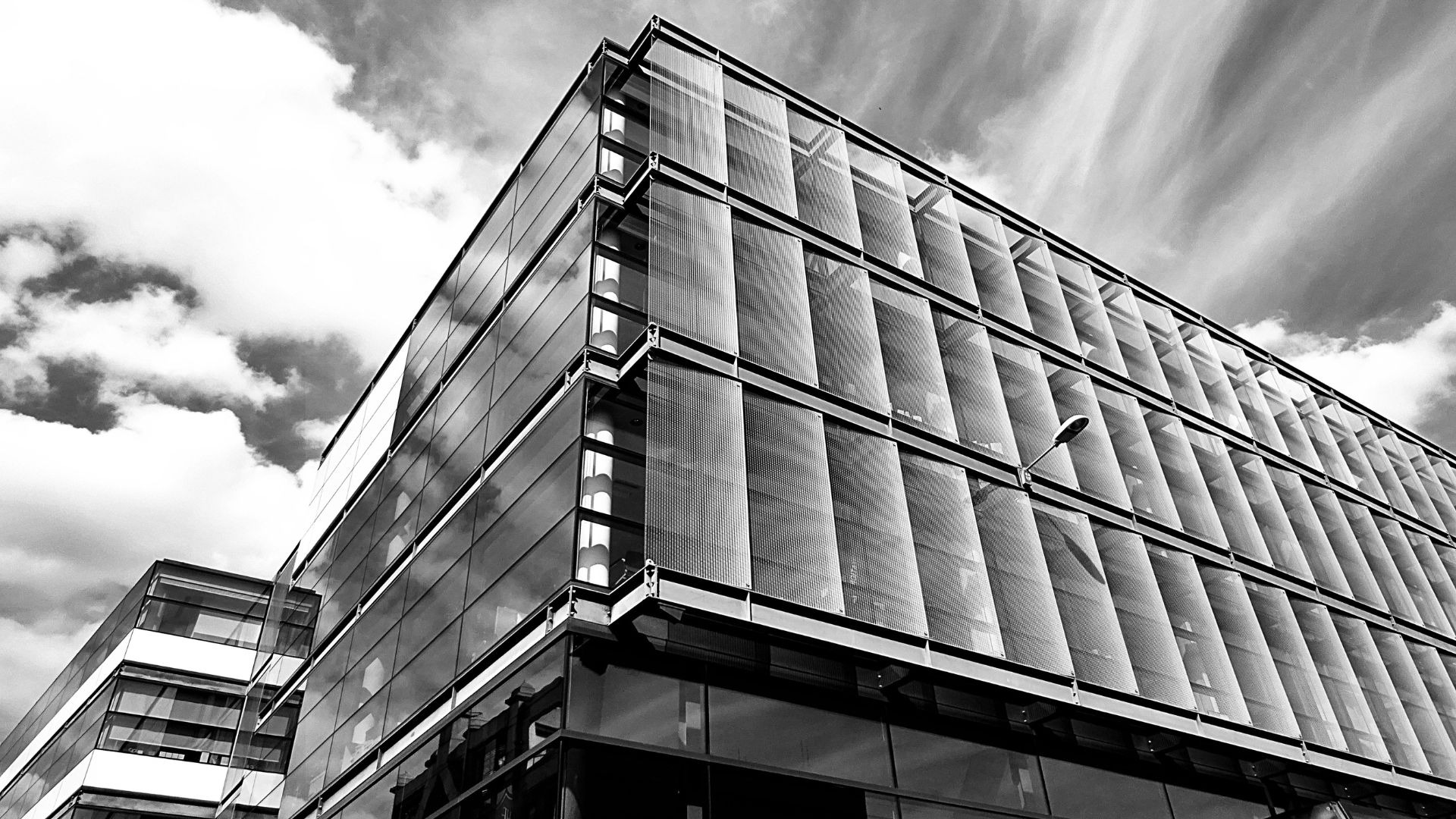 an abstract photo of a curved building with a blue sky in the background