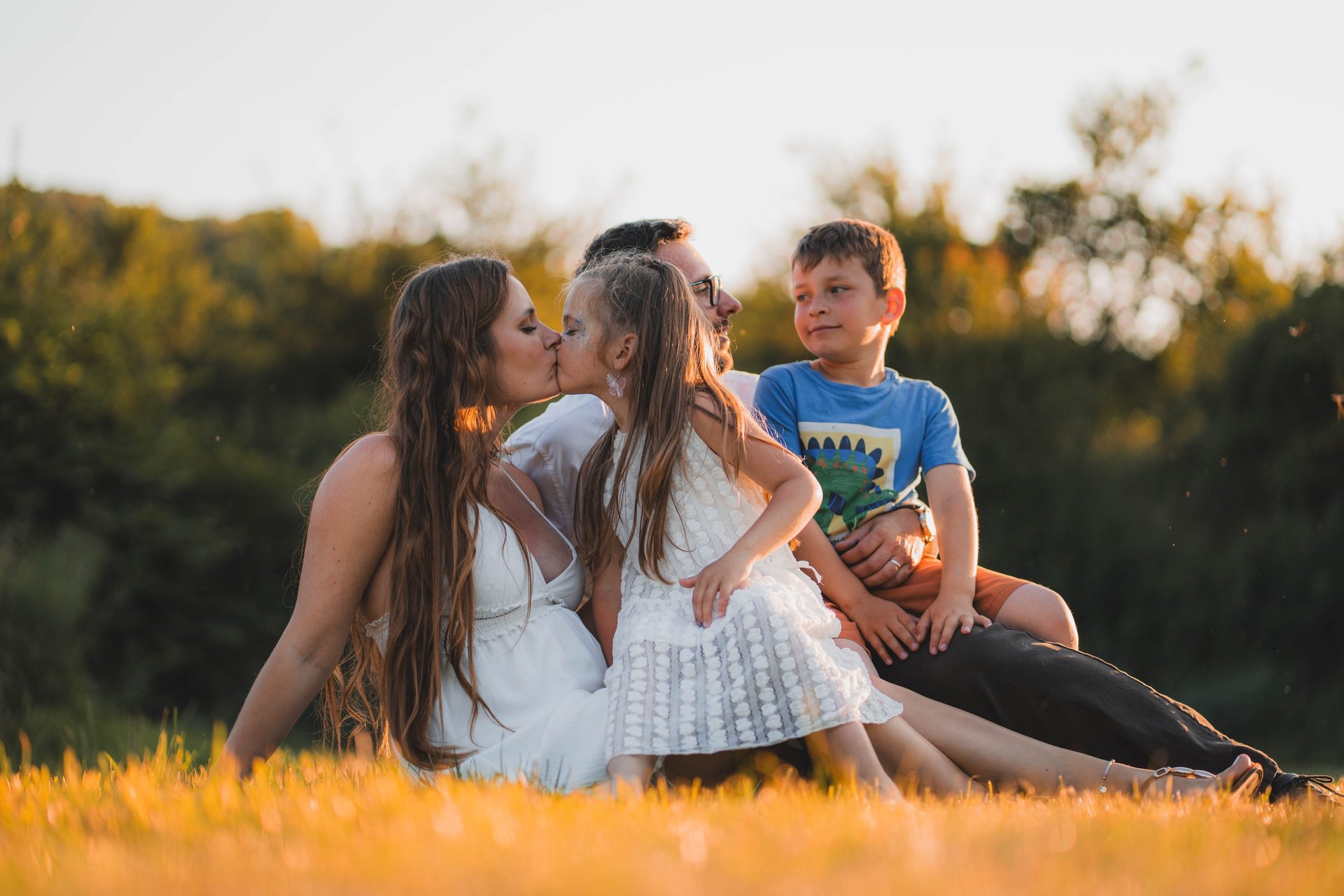 smiling man standing near green trees