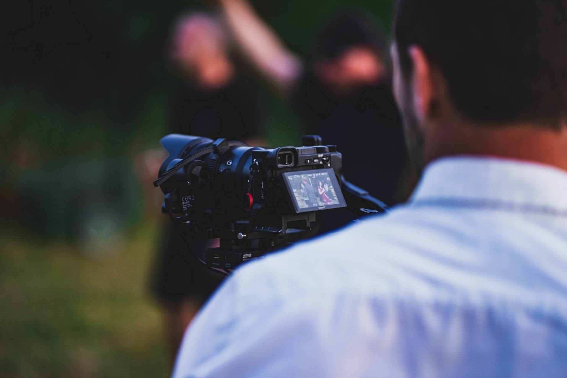 black video camera on brown grass field during daytime