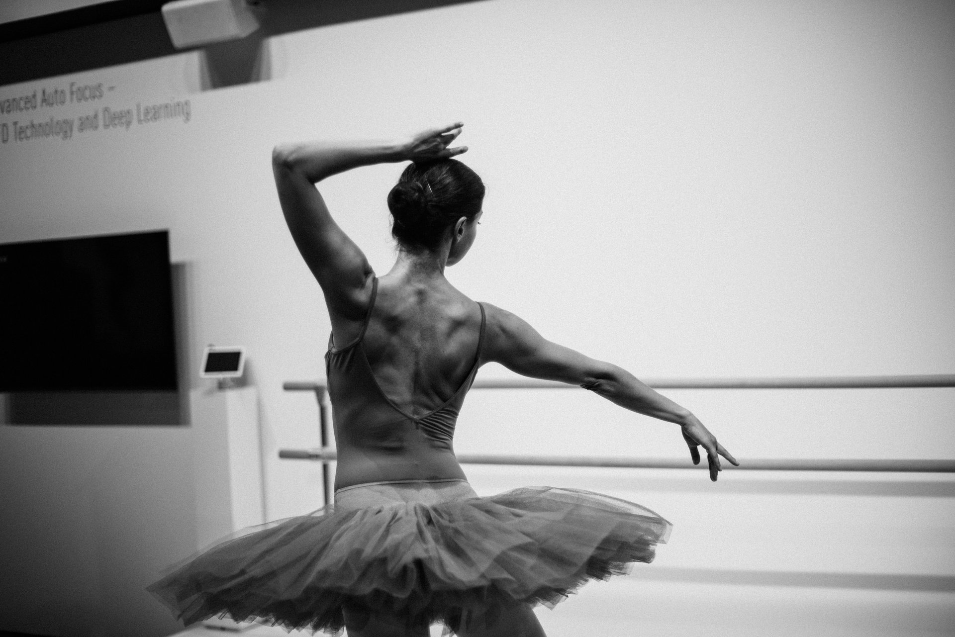 group of ballerinas dancing while raising both hands