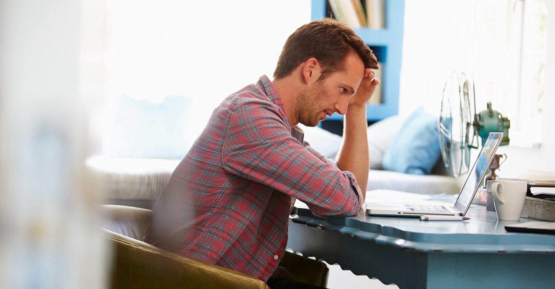 Overwhelmed business owner working at home