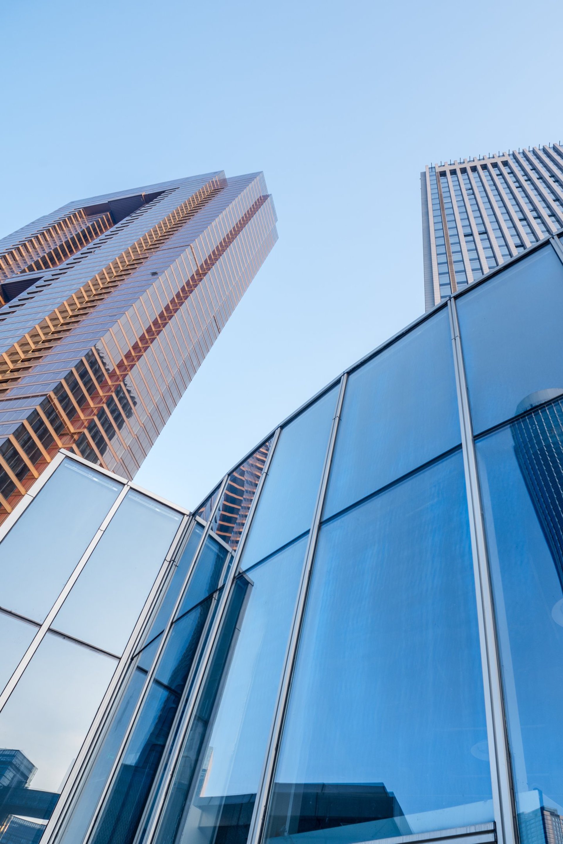 an abstract photo of a curved building with a blue sky in the background