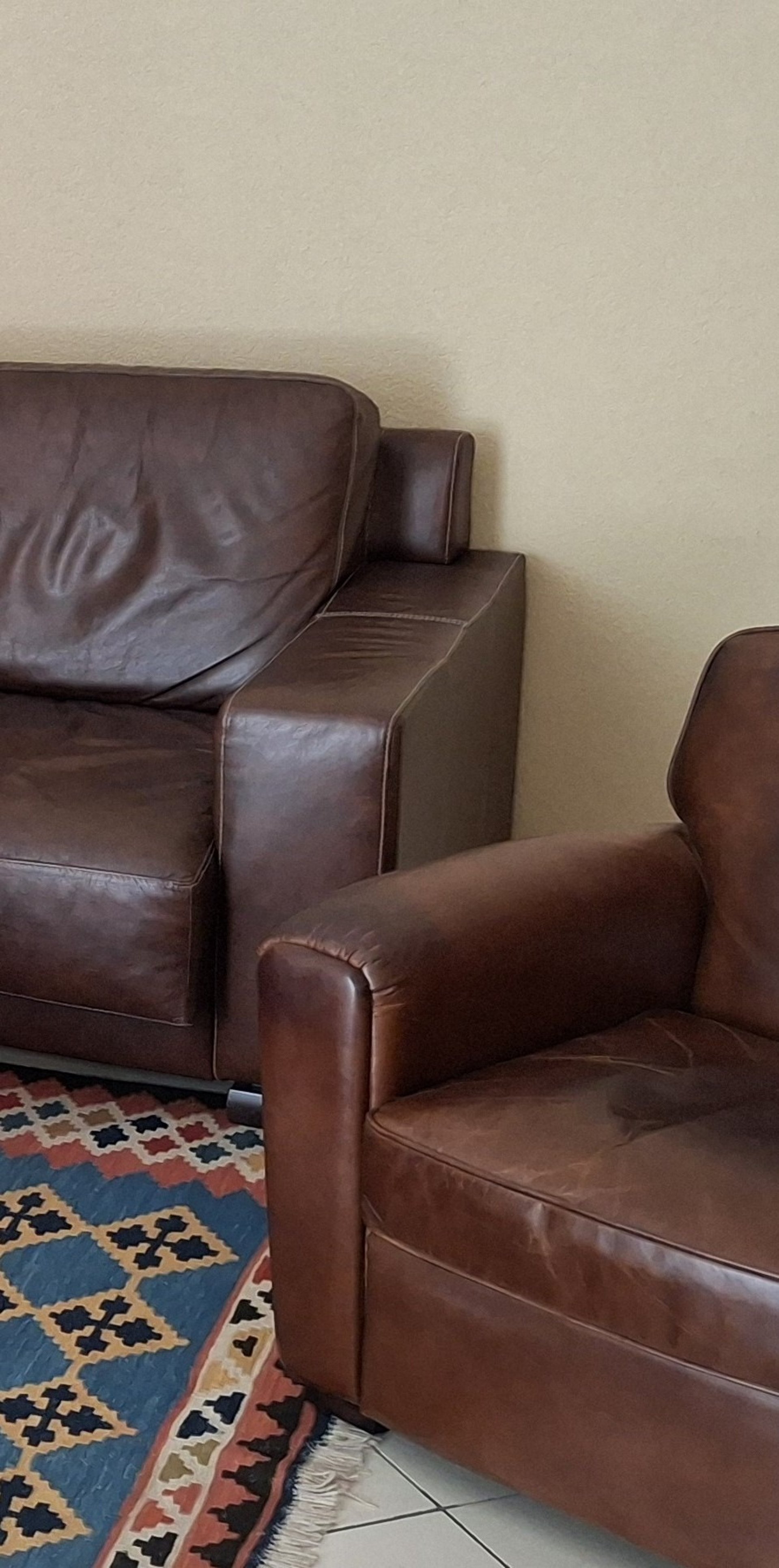 black and brown leather padded tub sofa