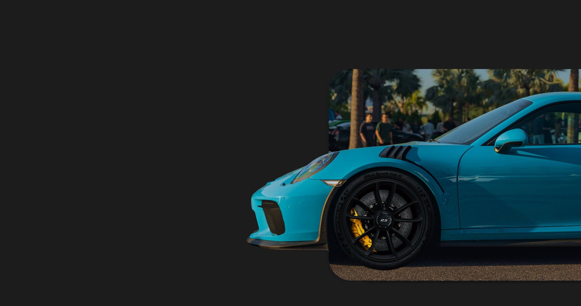 a blue and orange sports car parked in a parking lot
