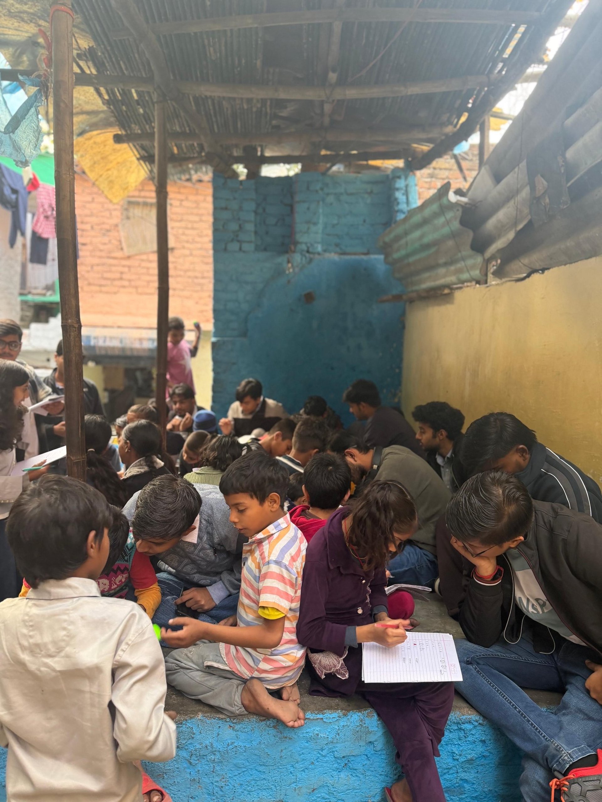 a group of young men sitting on top of a picnic table