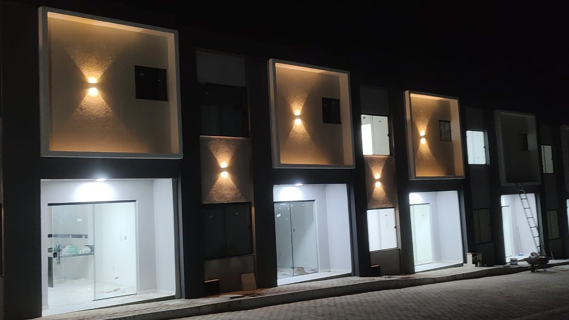 an abstract photo of a curved building with a blue sky in the background