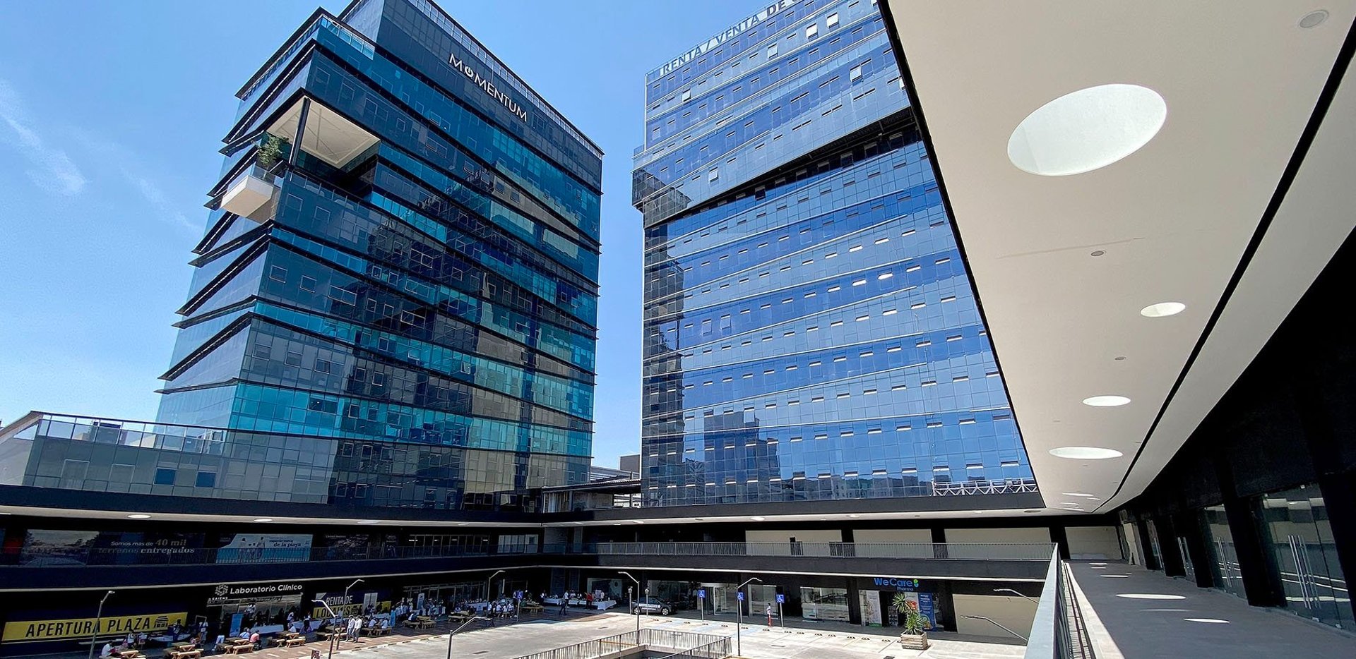an abstract photo of a curved building with a blue sky in the background