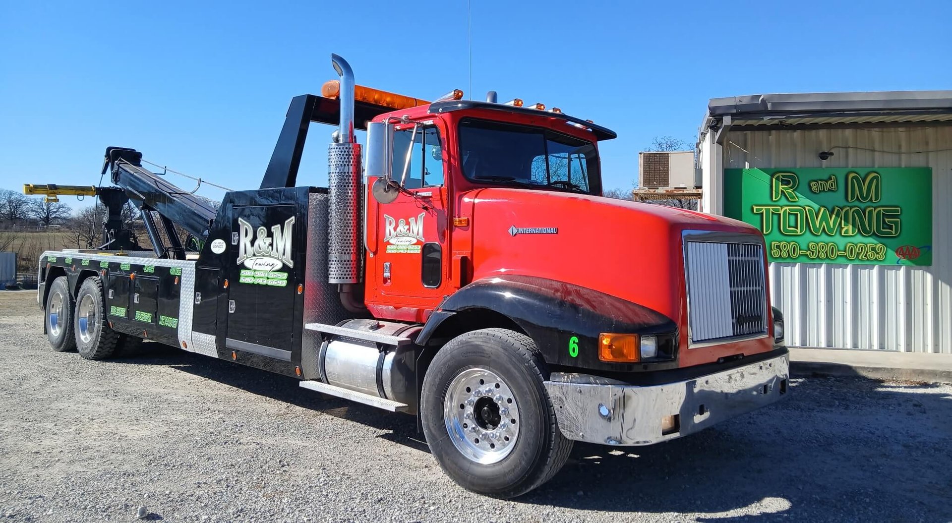 A tow truck towing a car on a flatbed
