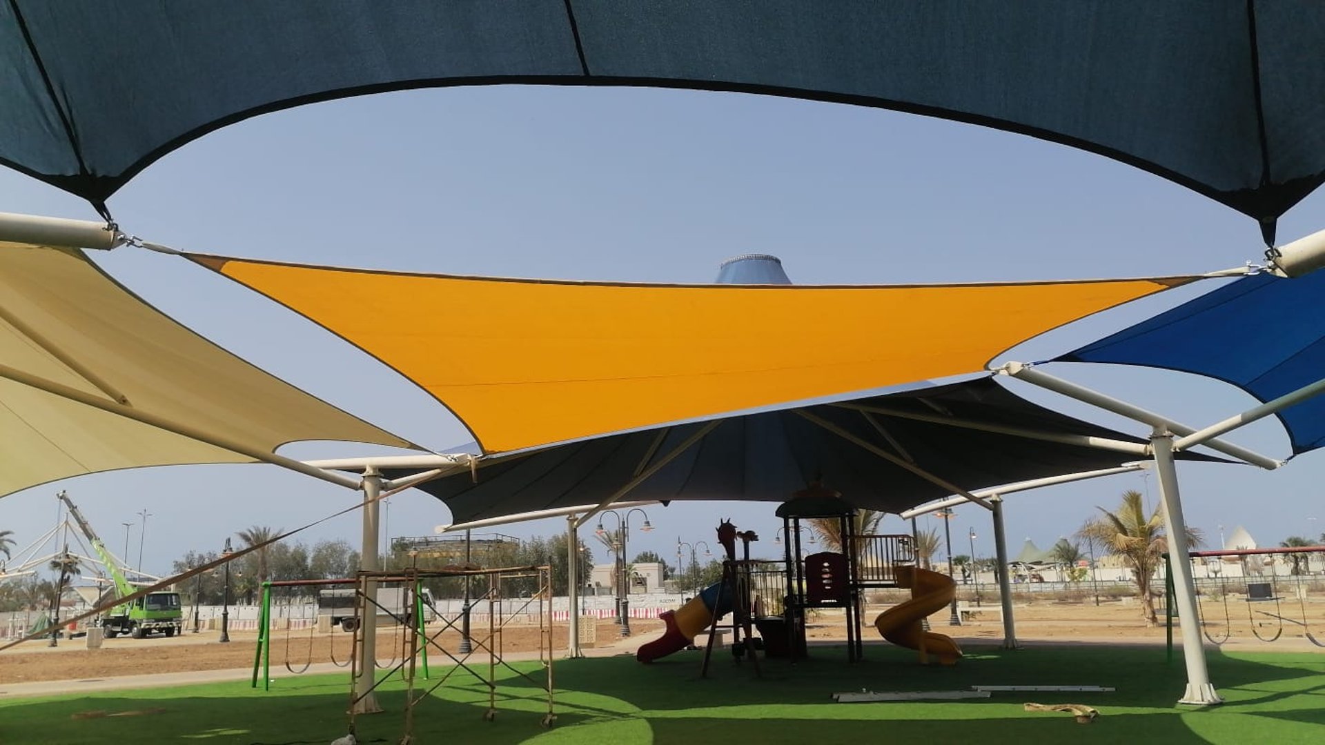 an abstract photo of a curved building with a blue sky in the background