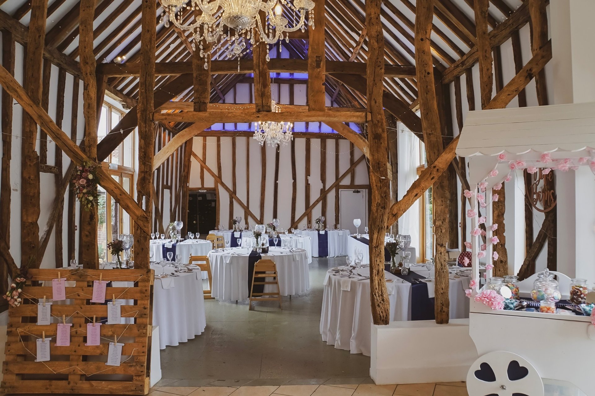 Beautiful barn converted wedding venue, with tables laid out ready for wedding breakfast