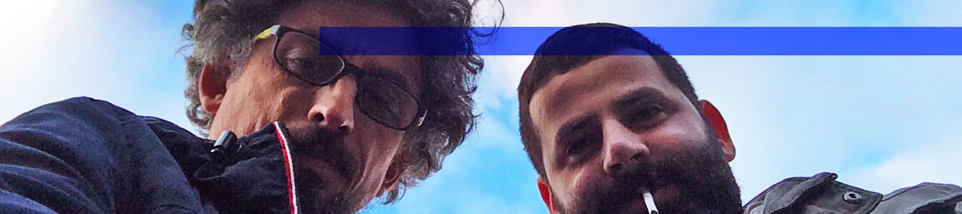 an abstract photo of a curved building with a blue sky in the background