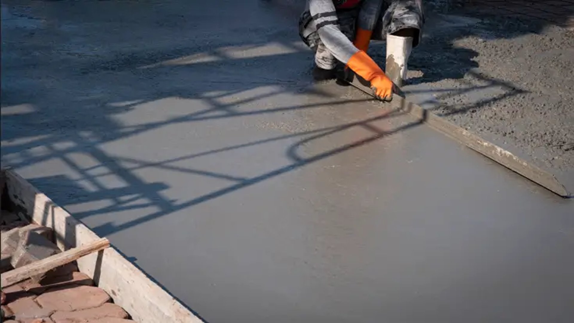 Man working on a freshly Poured Concrete along walkways in Florida