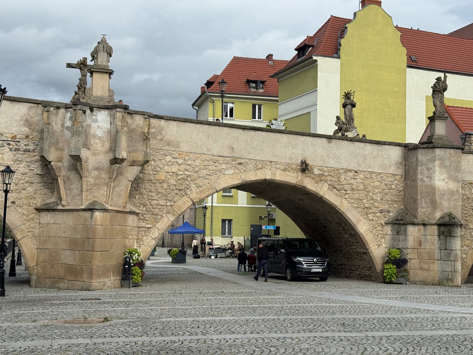 woman wearing yellow long-sleeved dress under white clouds and blue sky during daytime