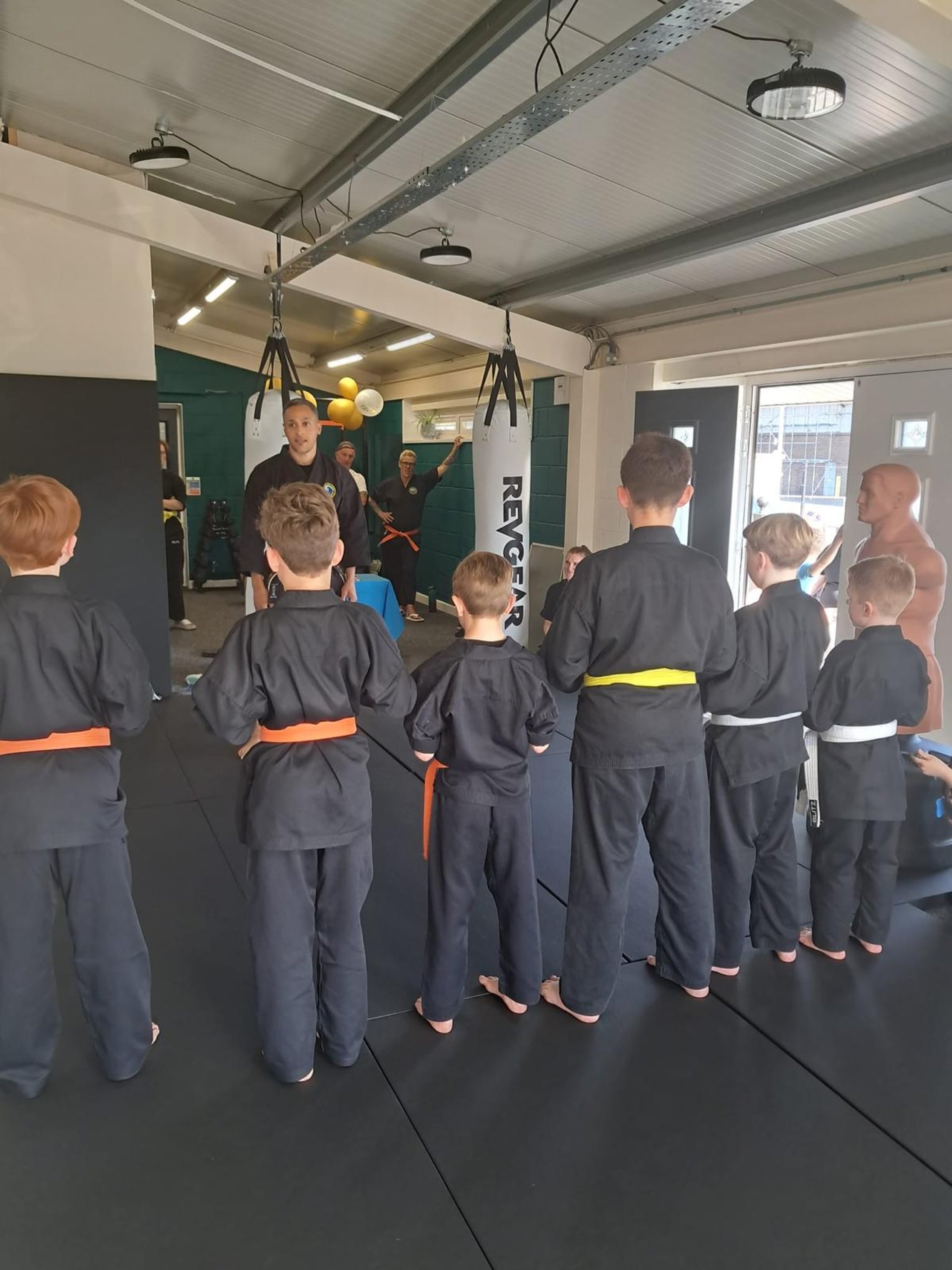 A group of people standing on top of a green floor