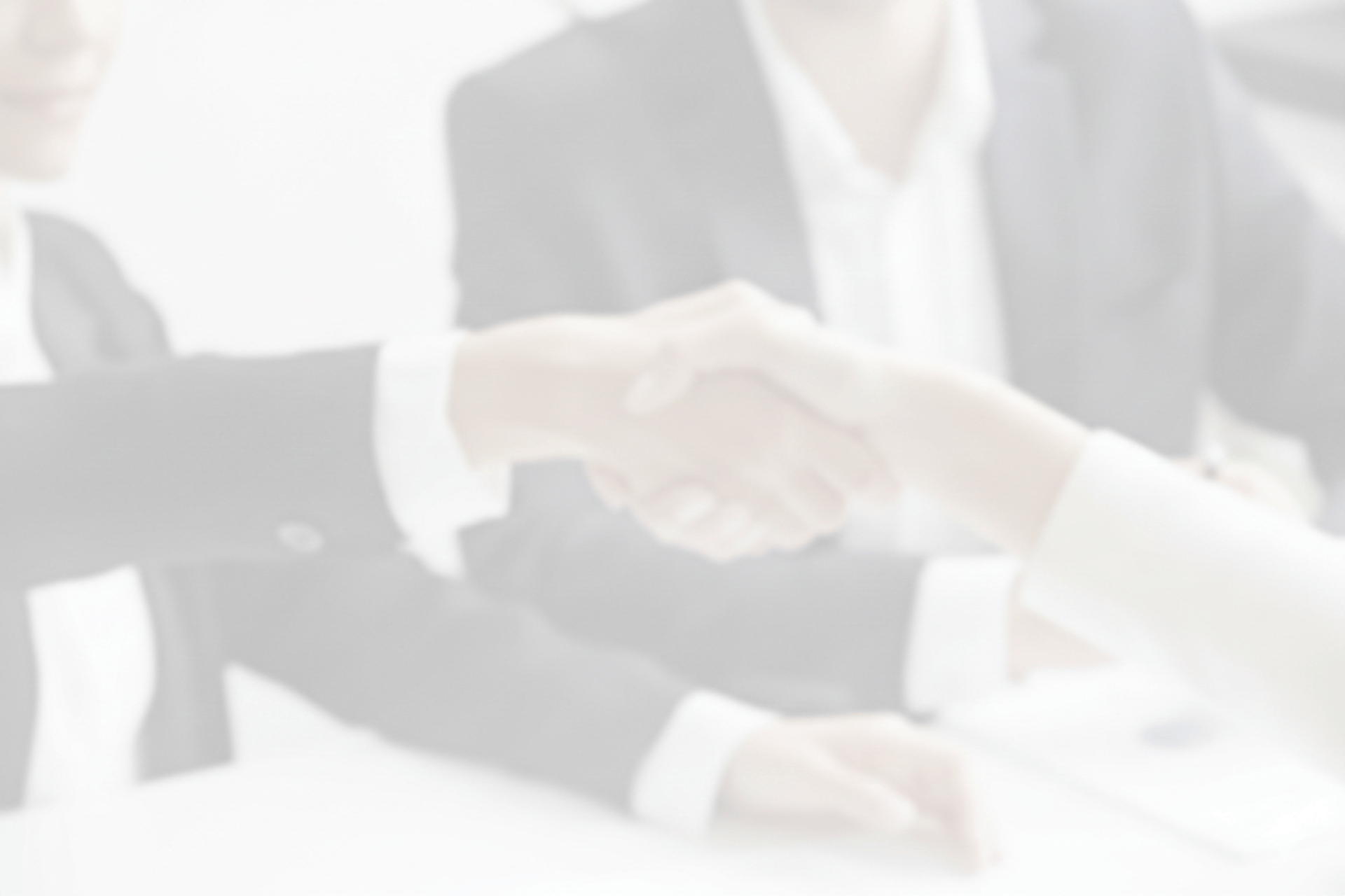 two people shaking hands in front of a laptop