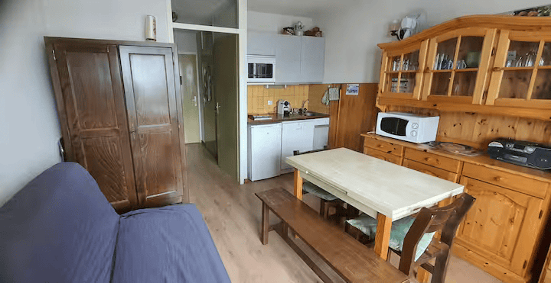 brown wooden house with green grass field