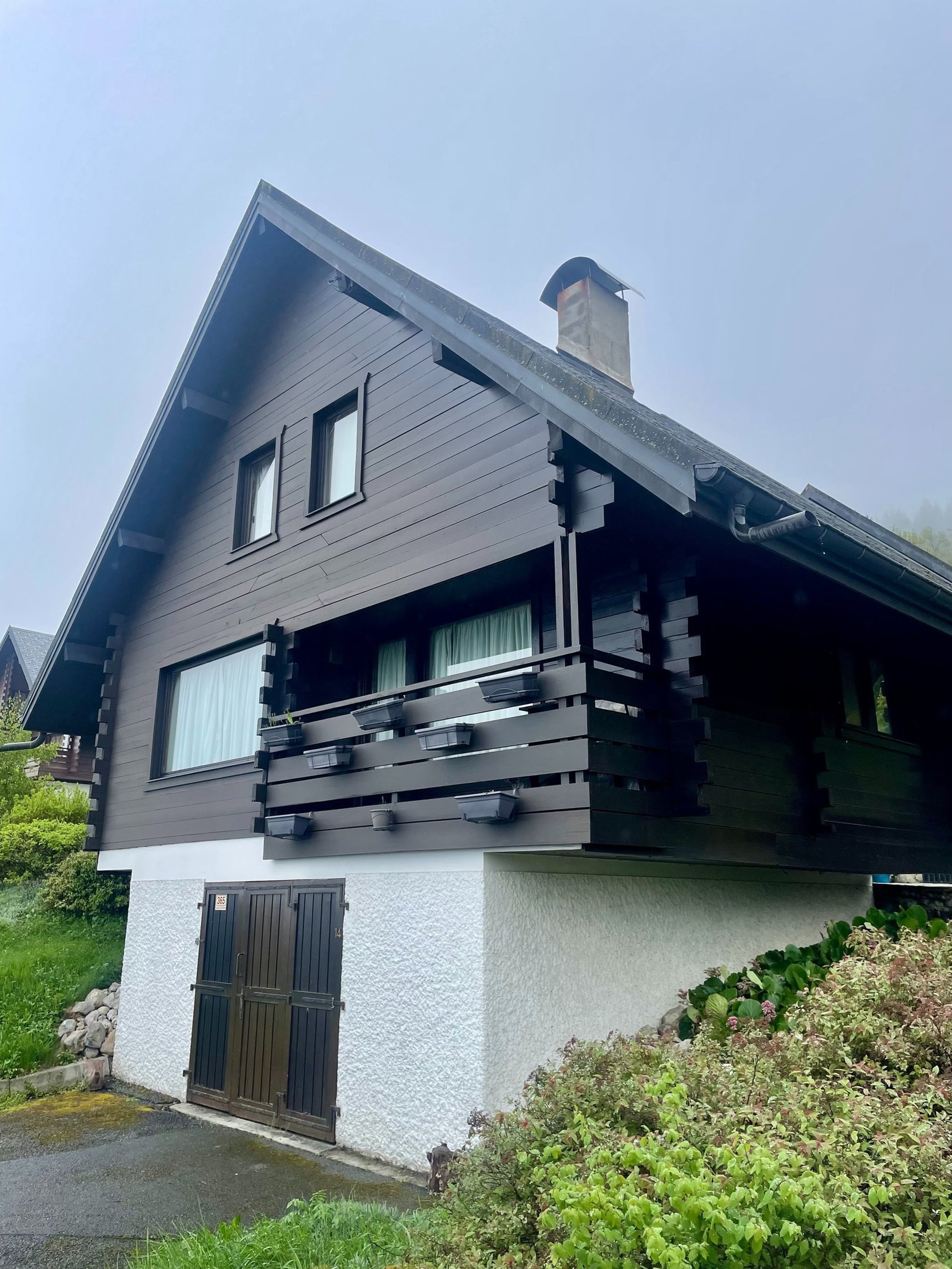 brown wooden house with green grass field