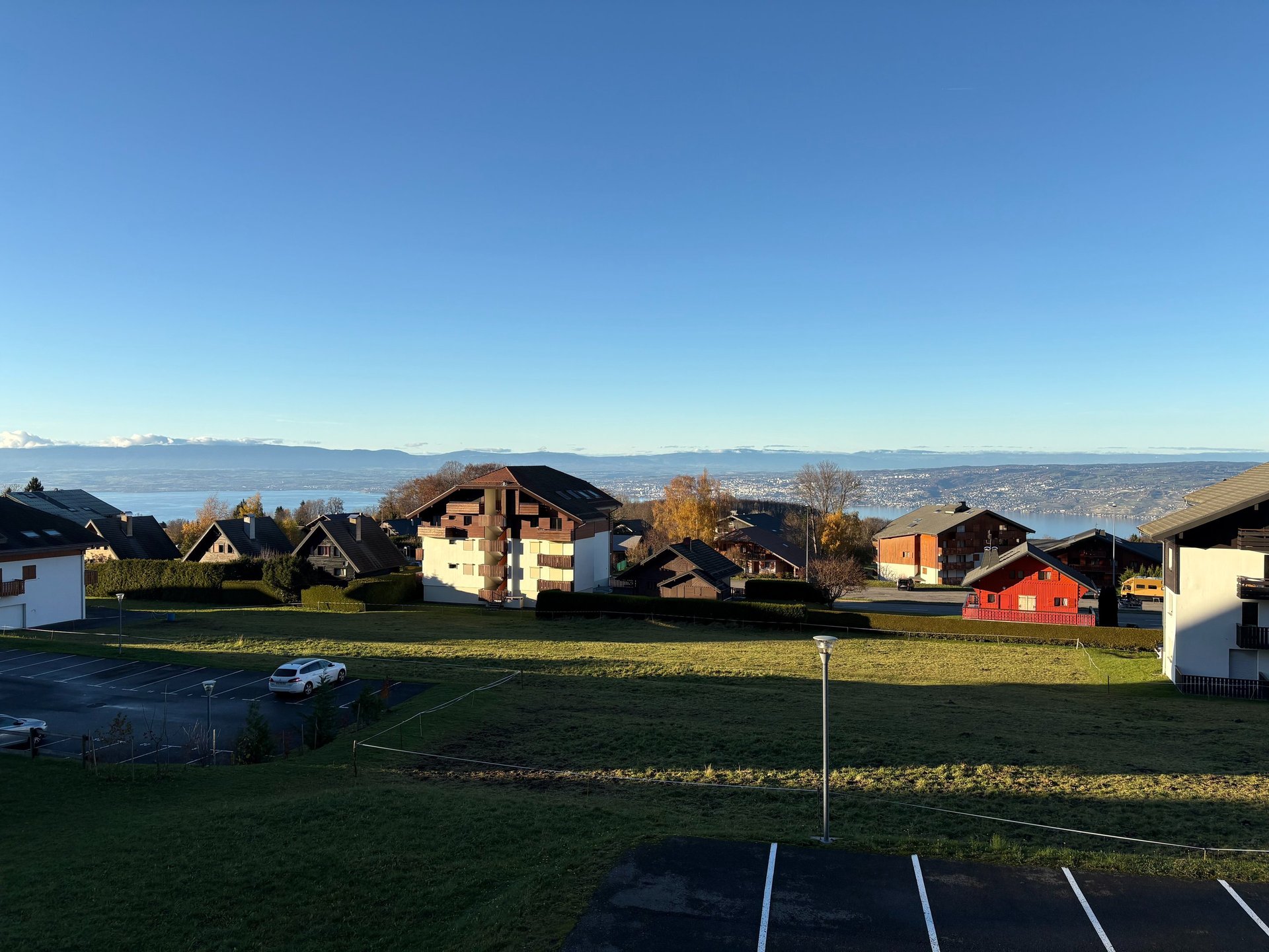 brown wooden house with green grass field