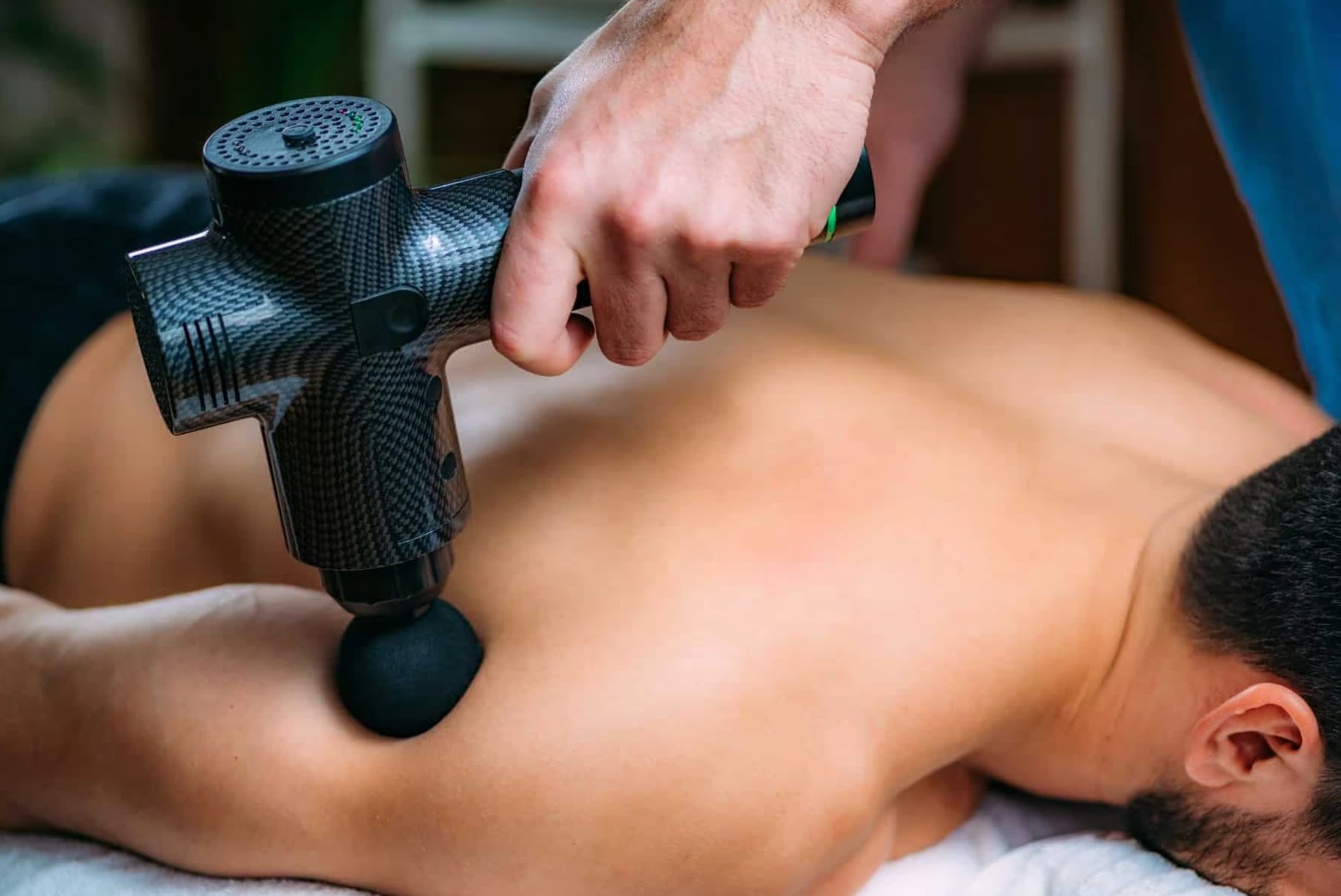 person holding black and gray cordless hand drill