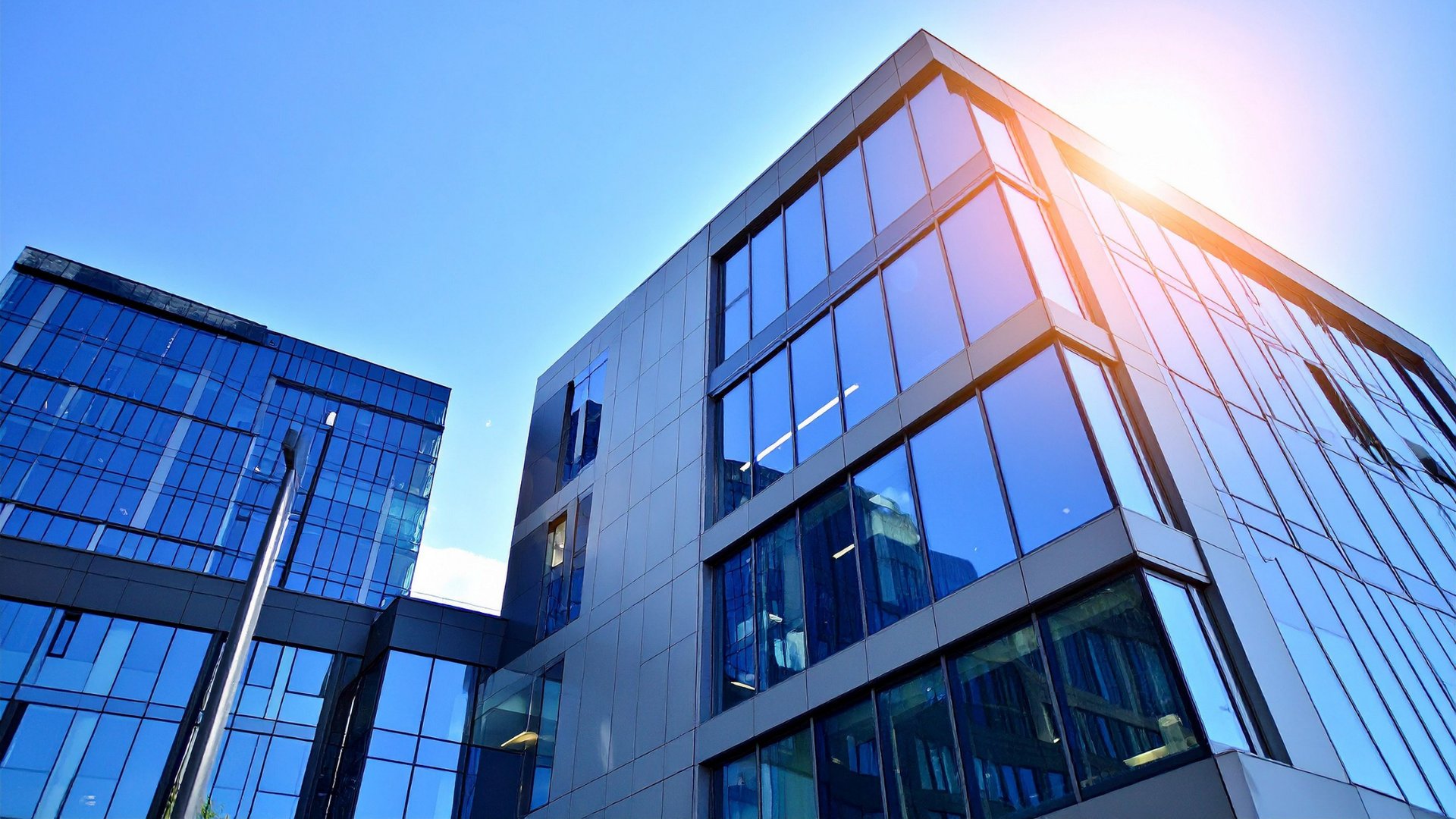 an abstract photo of a curved building with a blue sky in the background