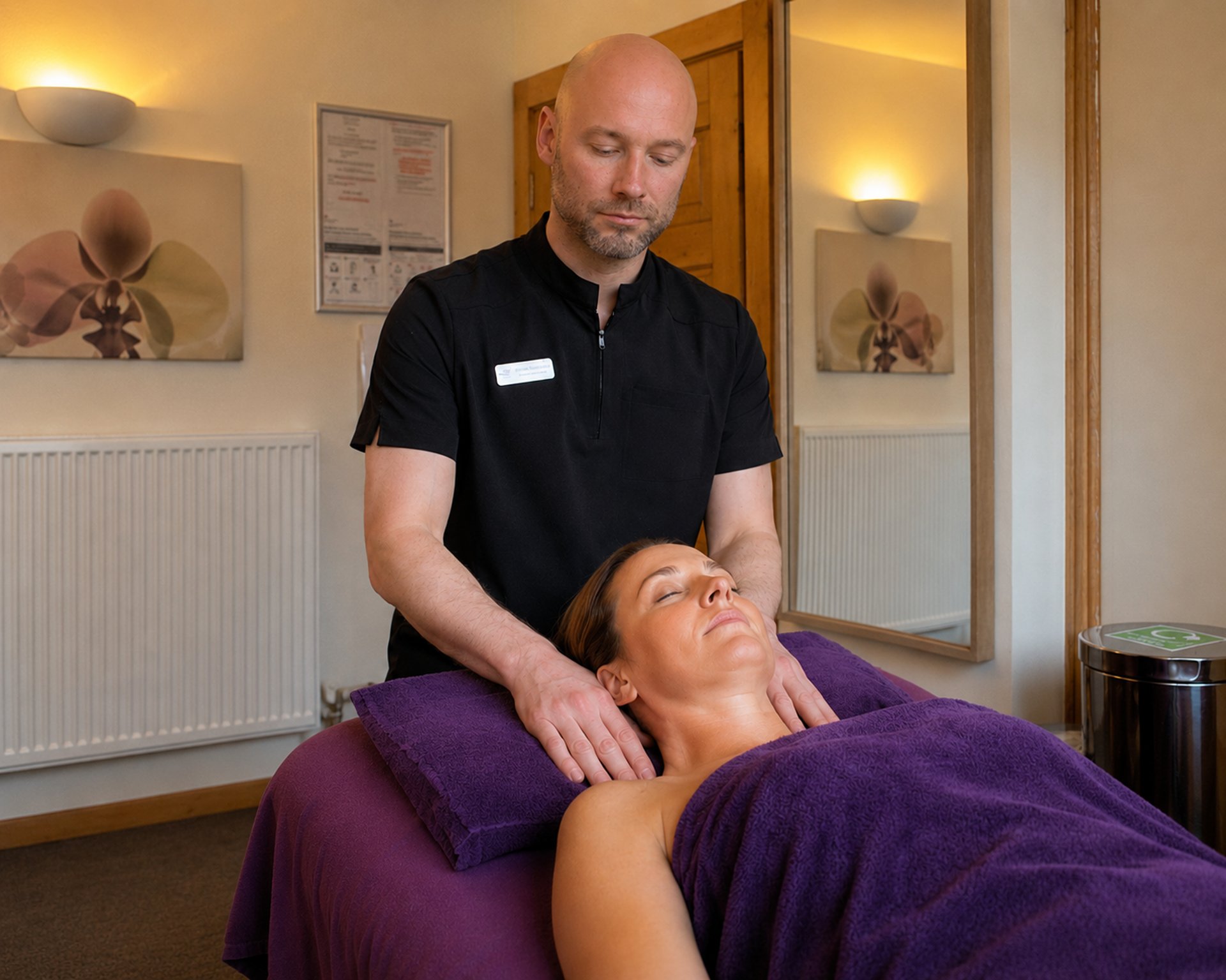 Massage therapist giving a back massage.