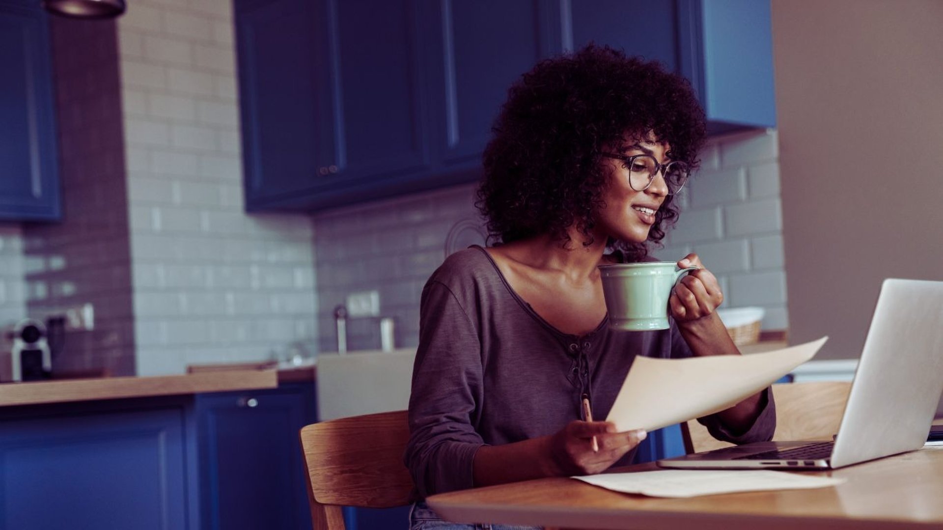 woman sitting on blanket located on shoreline