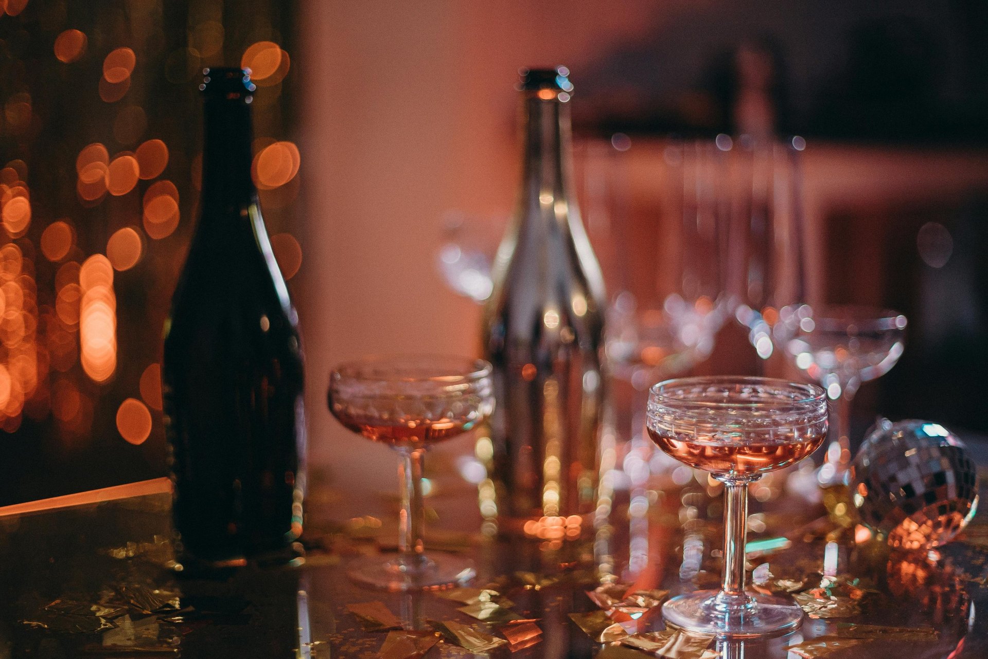 person pouring wine on glass