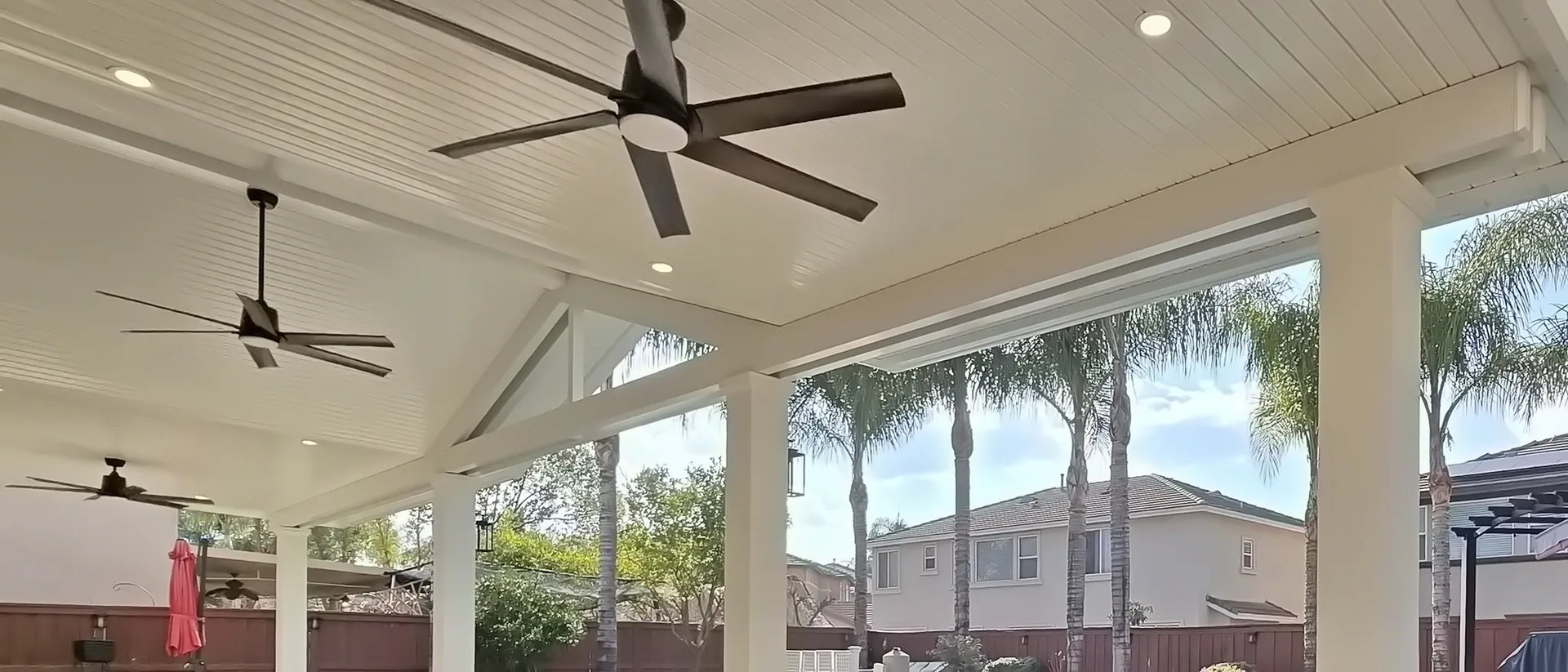Alumawood patio cover in Menifee CA with insulated roof, gable design, and ceiling fans by backyard pool