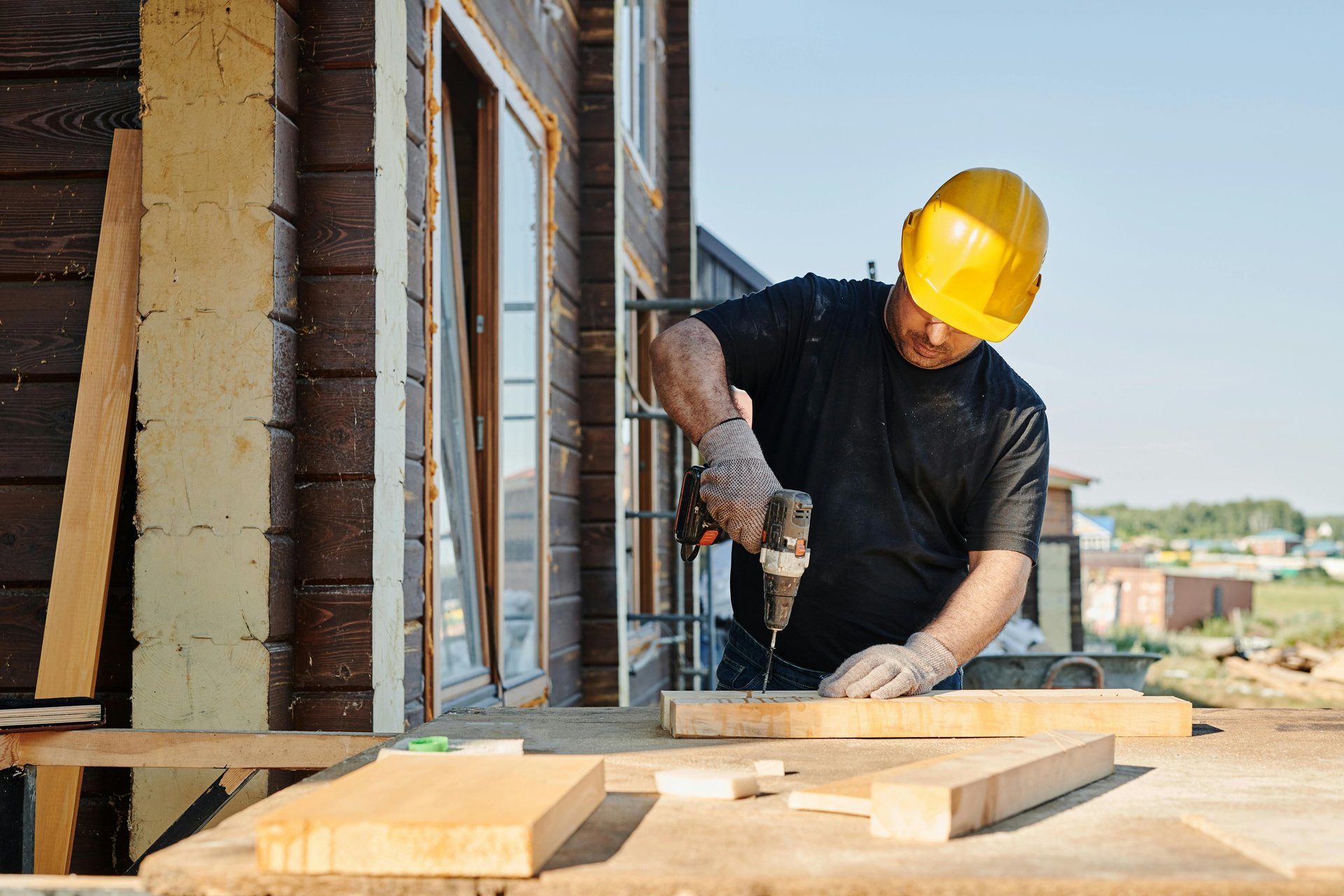 man in yellow shirt and blue denim jeans jumping on brown wooden railings under blue and