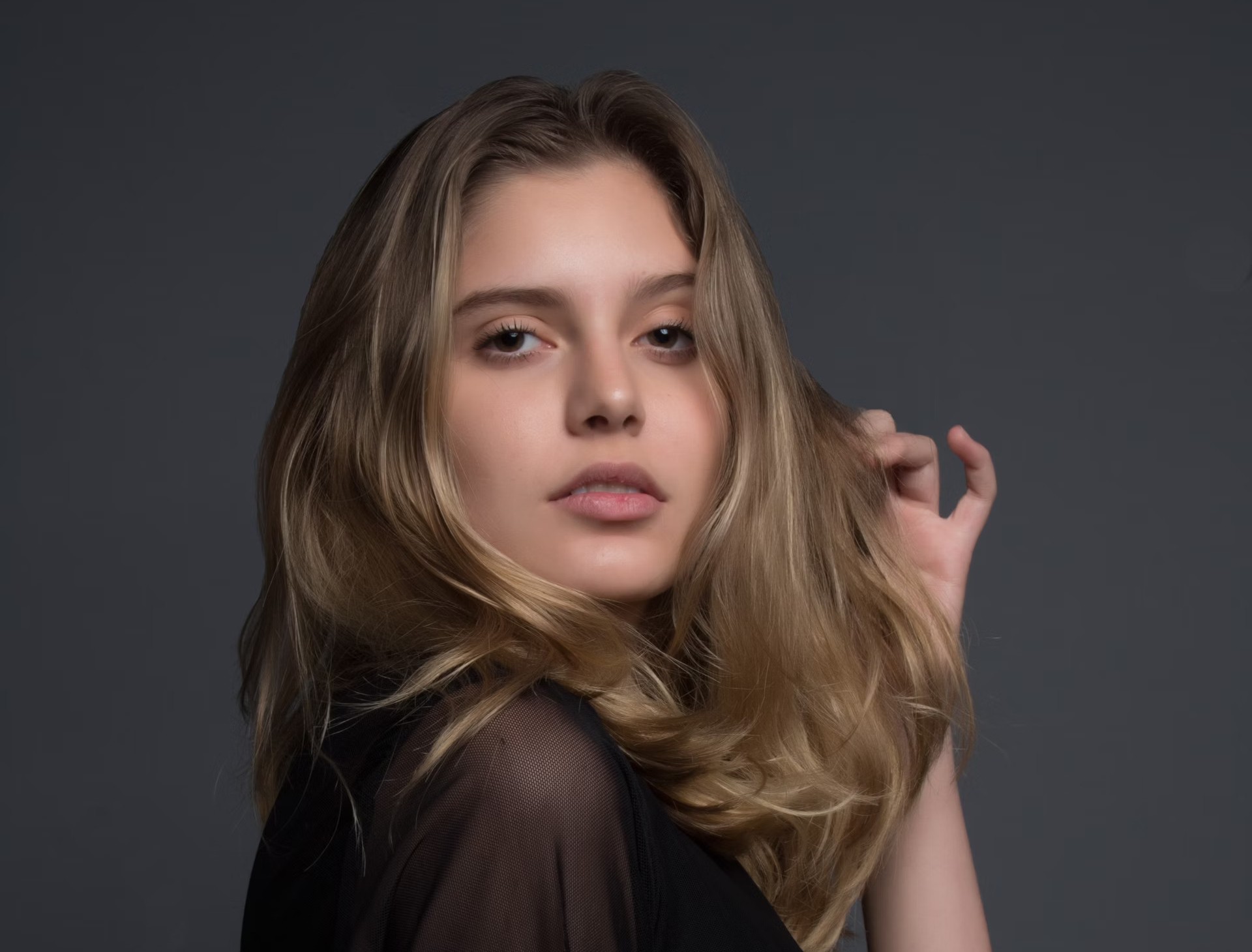woman holding heft long blonde hair