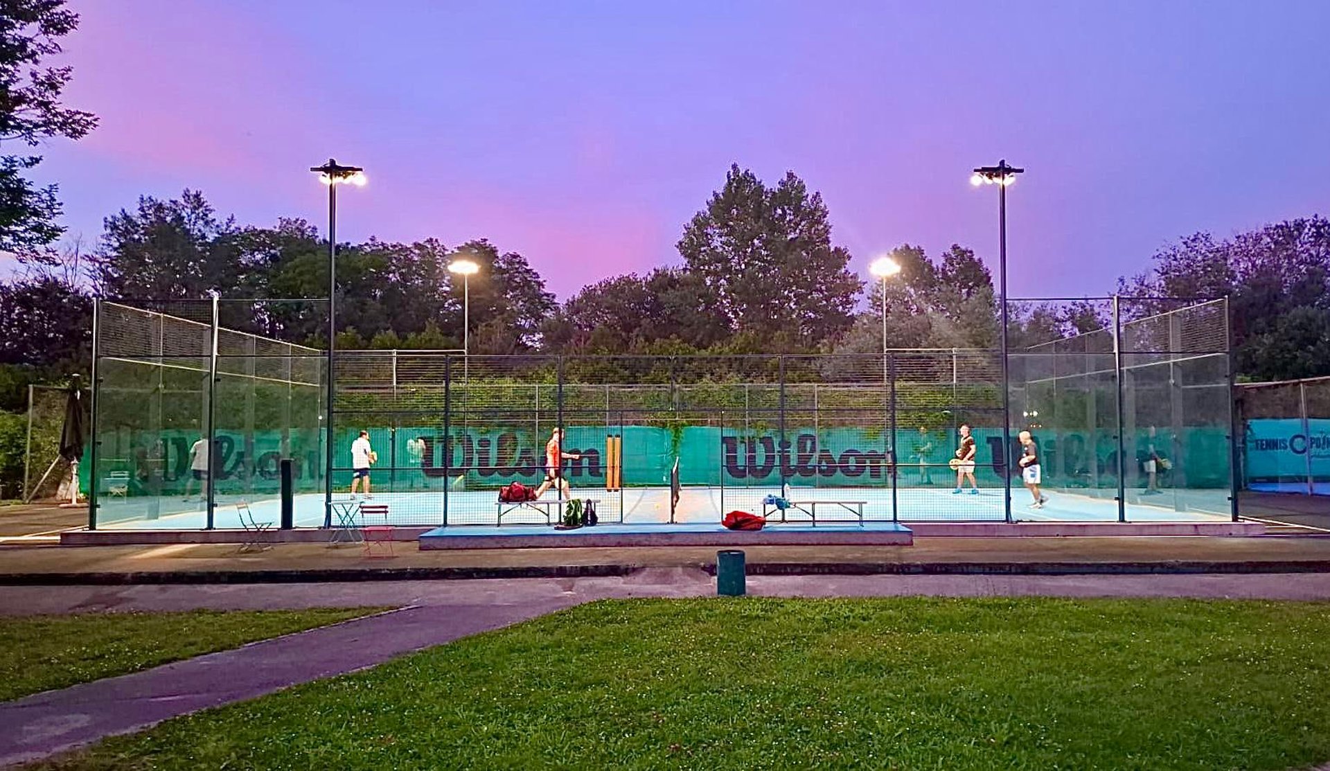 a tennis court with a fence surrounding it