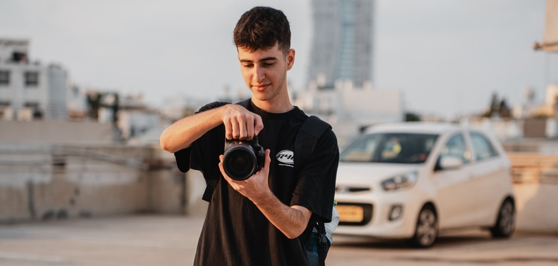 person holding Canon DSLR camera
