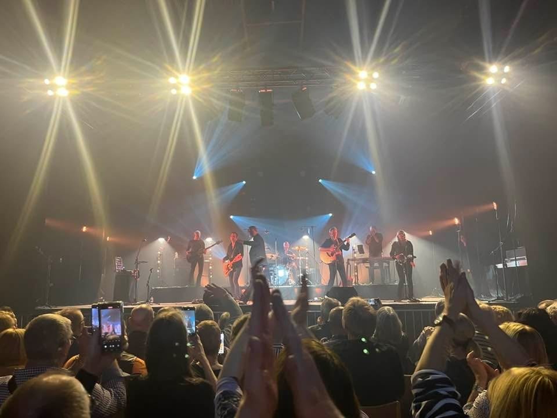 an abstract photo of a curved building with a blue sky in the background