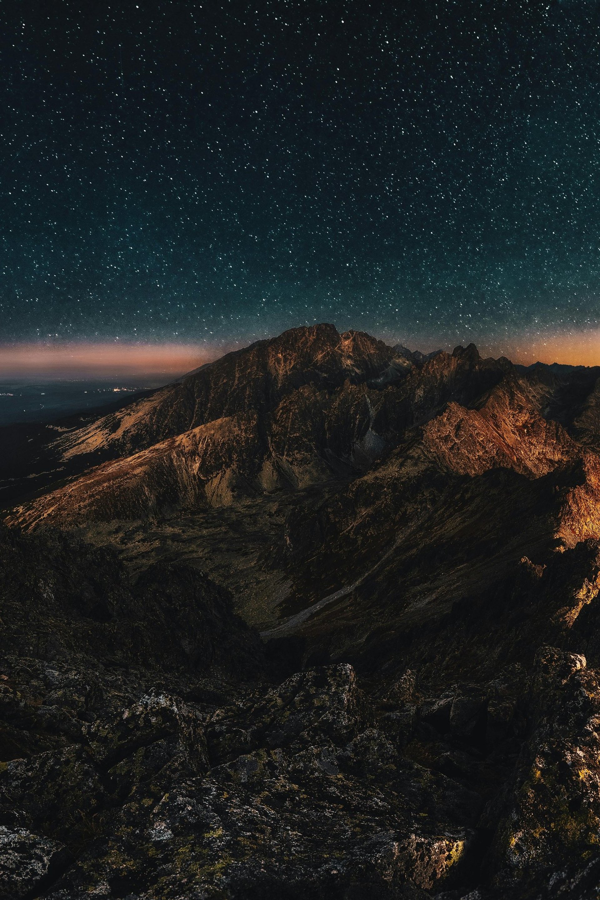 calm body of water near alp mountains during nighttime