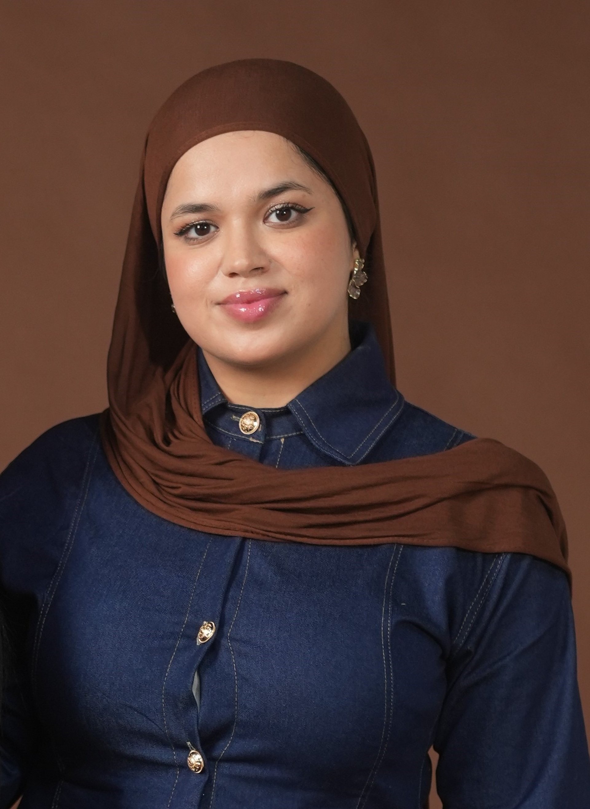 an abstract photo of a curved building with a blue sky in the background