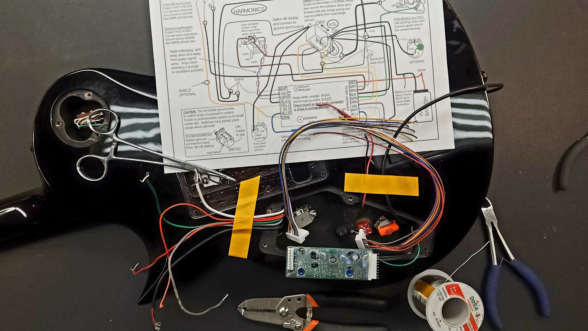 a close up of a guitar on a black background